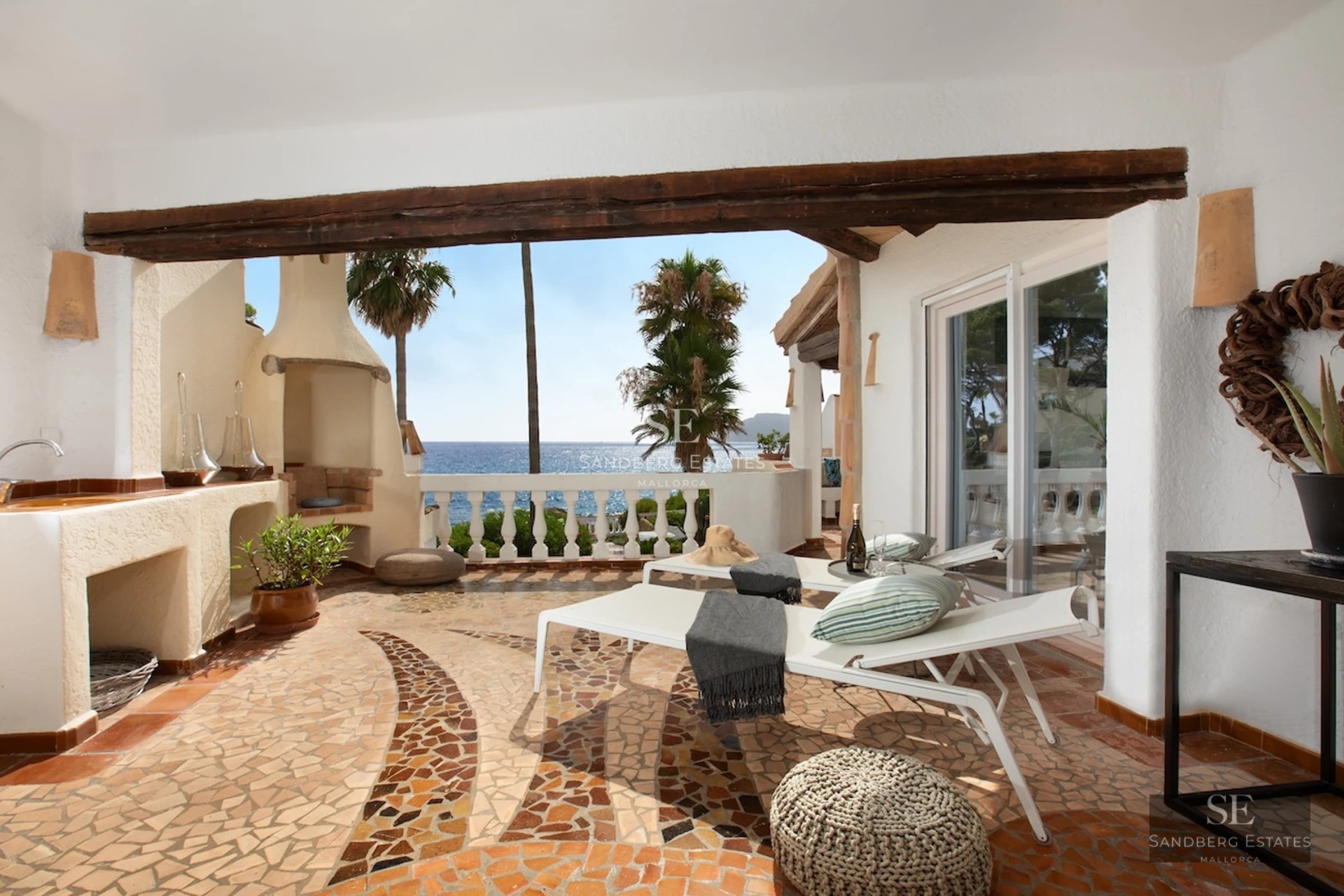 Spacious balcony with infinity pool and panoramic sea views. Modern design, elegant outdoor furniture.