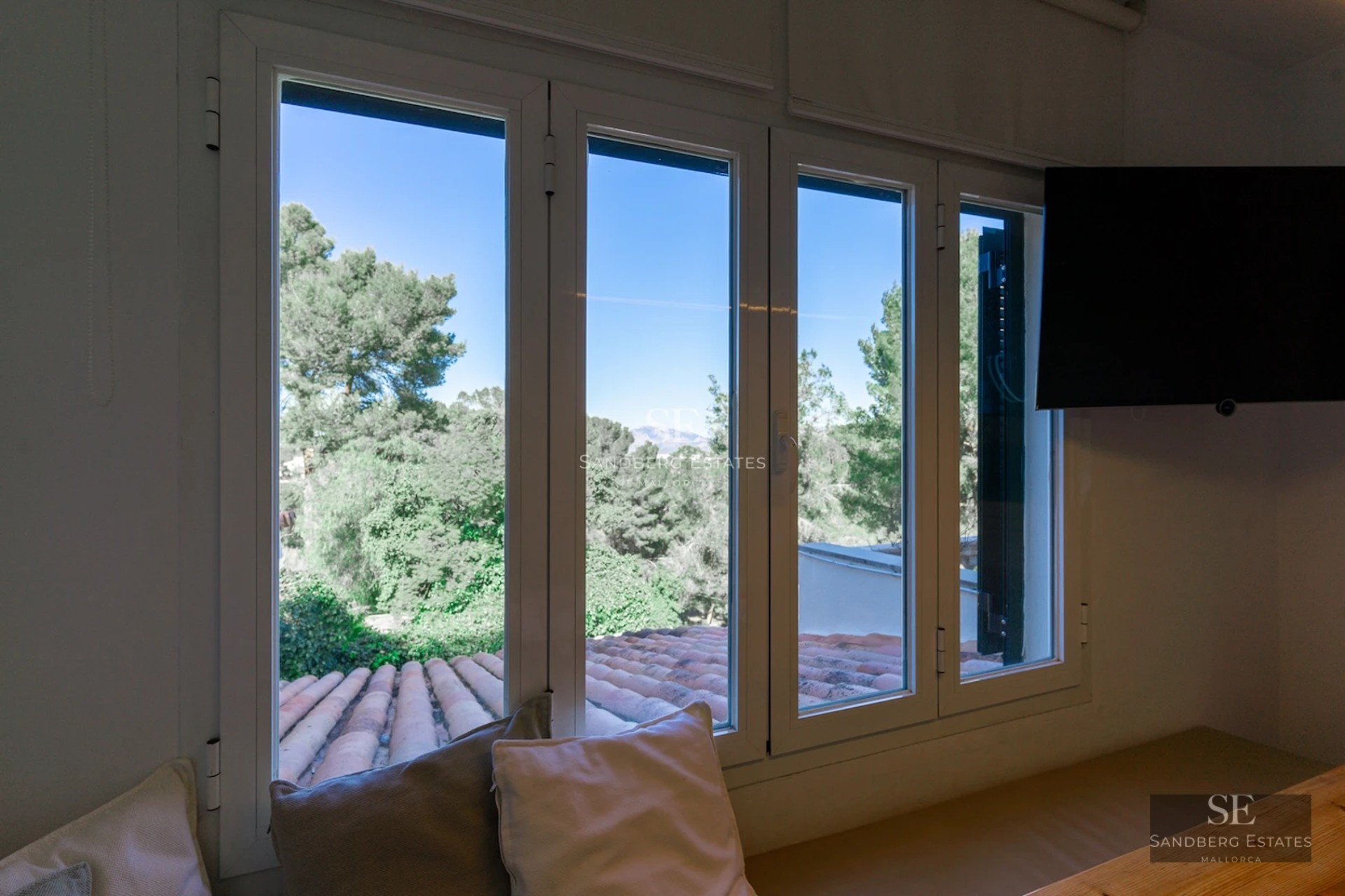 Aerial view of modern house with infinity pool, lush garden, and spacious terraces. Minimalist and elegant design.