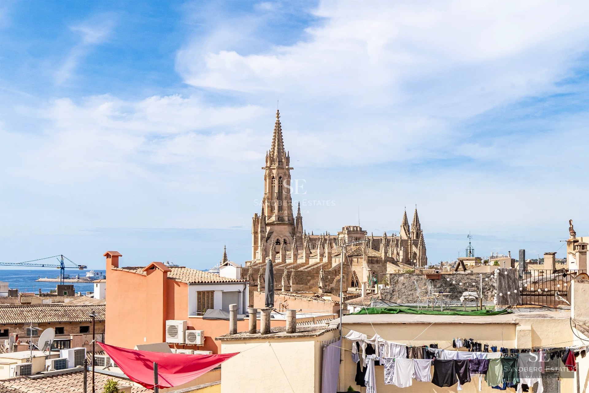 Exterior view of a modern villa featuring an infinity pool, lush garden, and expansive terraces. Minimalist architectural design with panoramic windows.