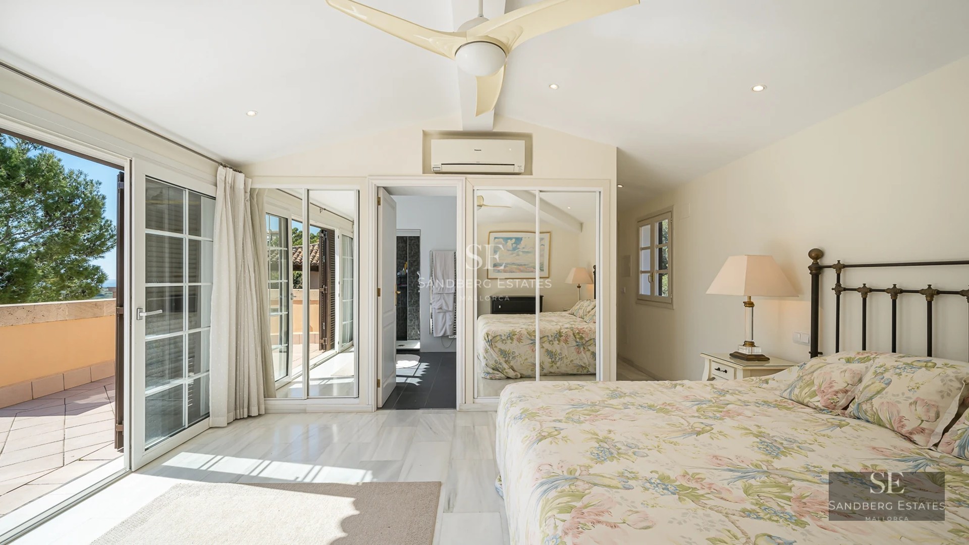 Spacious living room with picture windows, sea view, light wood floors, modern sofas, and terrace access. Minimalist and bright design.