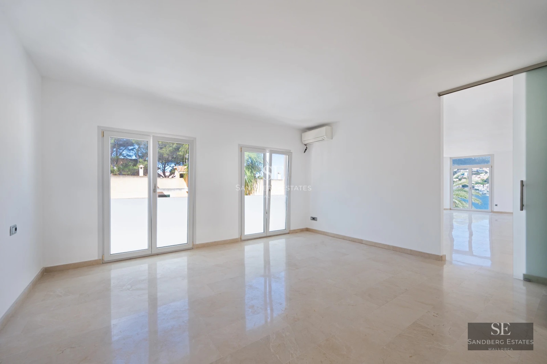 Spacious terrace featuring a pool, sun loungers, and panoramic views. Modern design with light flooring and glass railing.