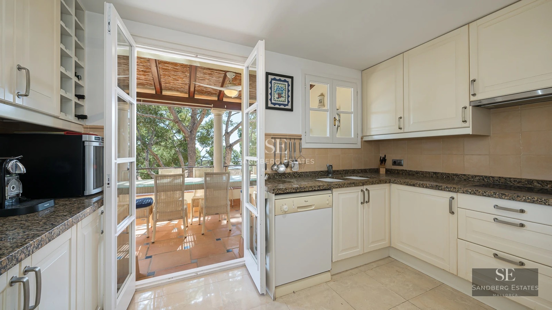 Spacious living room with large windows, light wood floors, modern furniture and access to terrace with panoramic views.