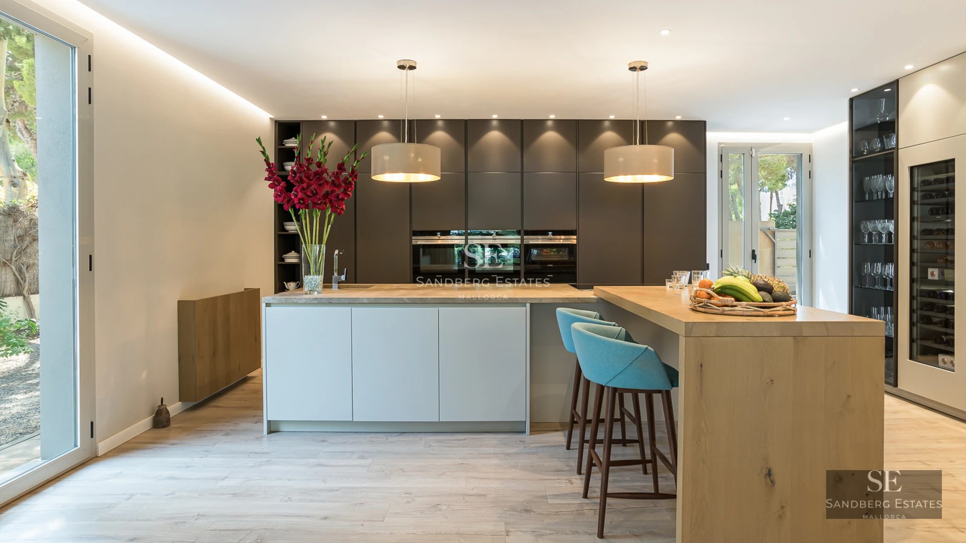 Exterior view of a luxurious house with an infinity pool, manicured garden, modern architecture, and large glass windows.