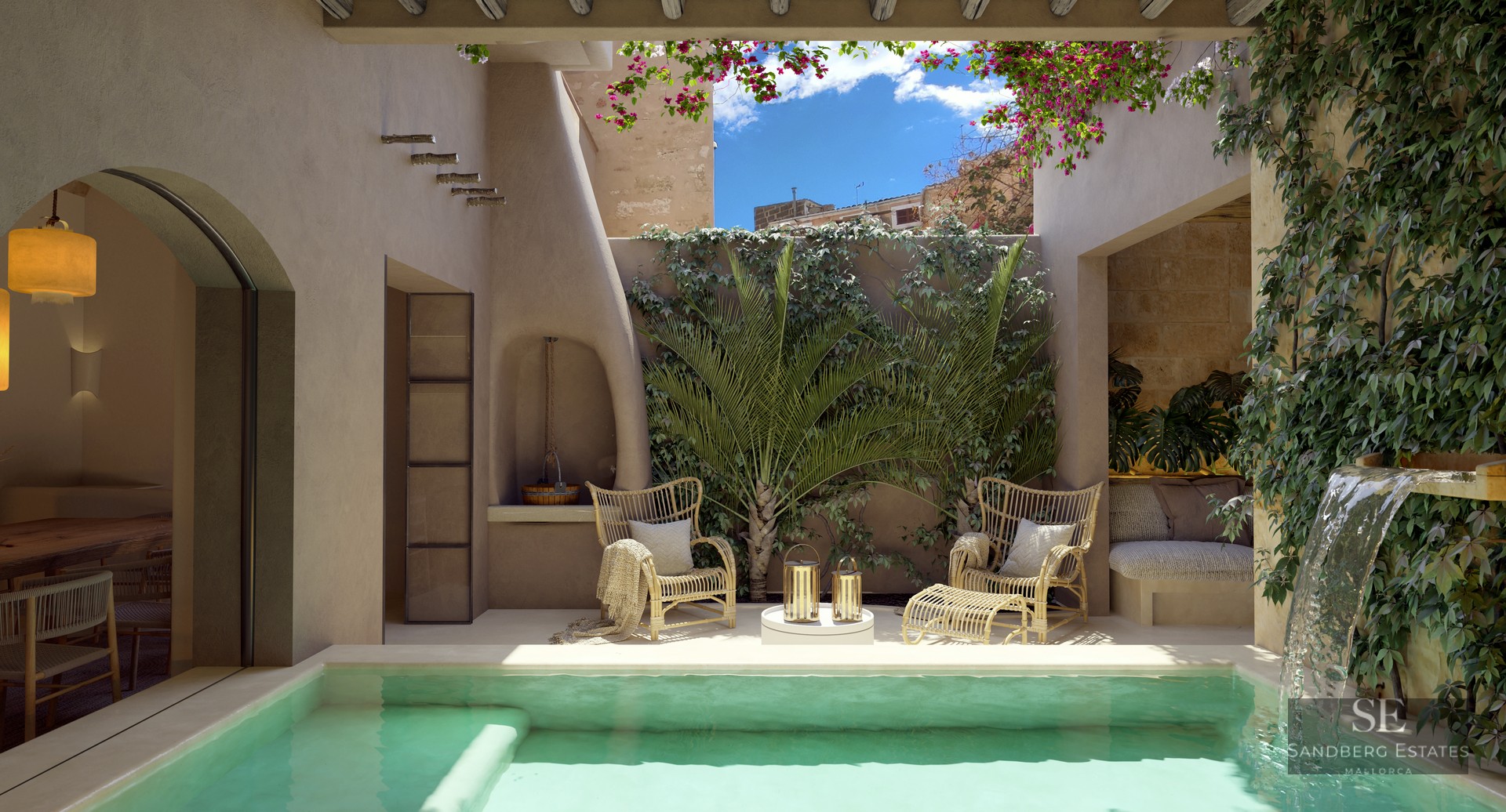 Sunlit courtyard with turquoise plunge pool, waterfall, wicker chairs, and lush greenery under a blue sky.
