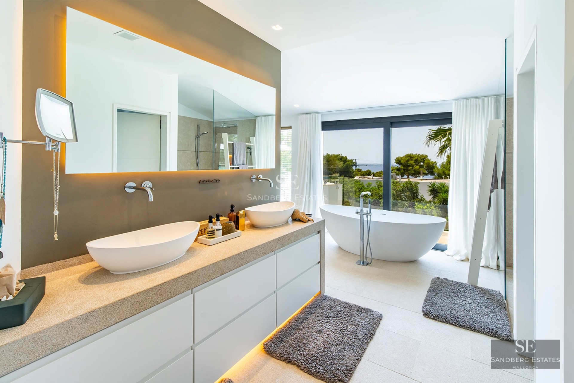 Exterior view of a modern villa featuring a reflecting pool, large windows, and minimalist design in neutral tones.