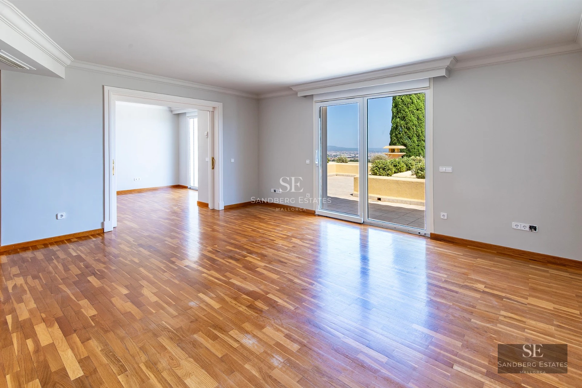 Exterior view of a modern villa with a pool, manicured garden, and minimalist architecture. Large windows and terraces.