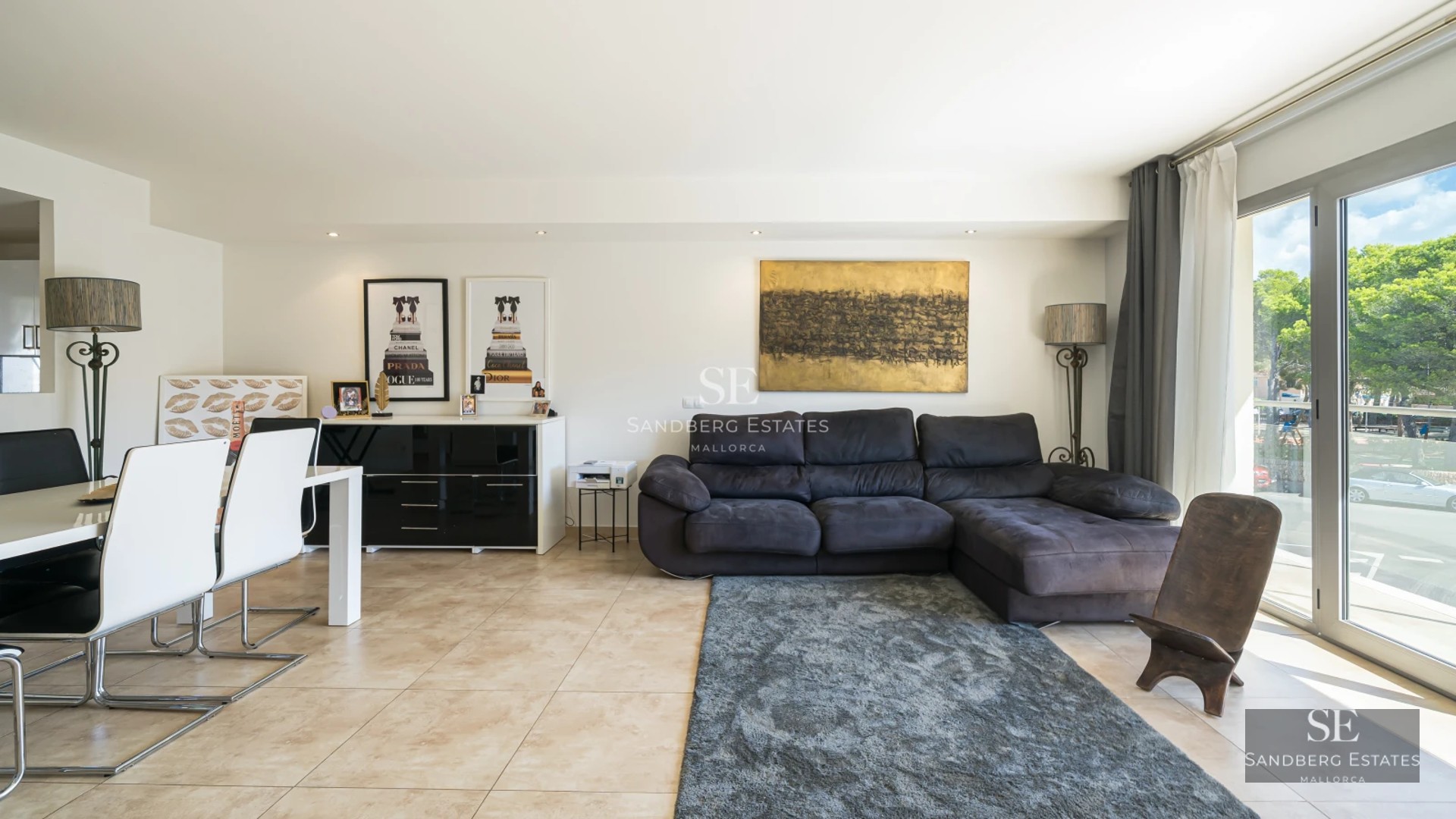 Villa view featuring infinity pool, sun loungers, and lush vegetation. Modern architecture with large windows and terrace. Relaxing landscape.