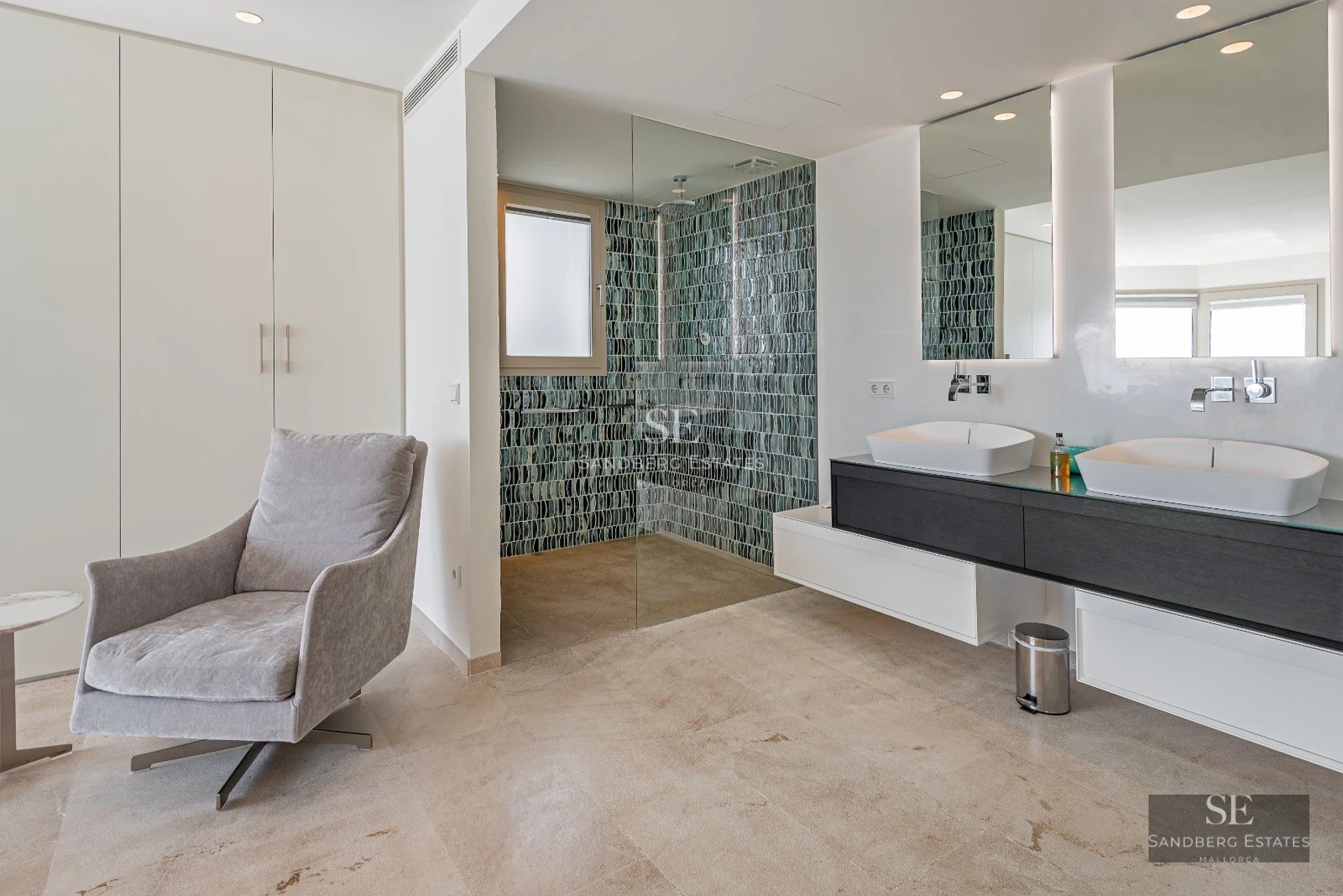 Bright living room with large windows offering panoramic sea views. Modern design, neutral colors, and luxurious furniture.