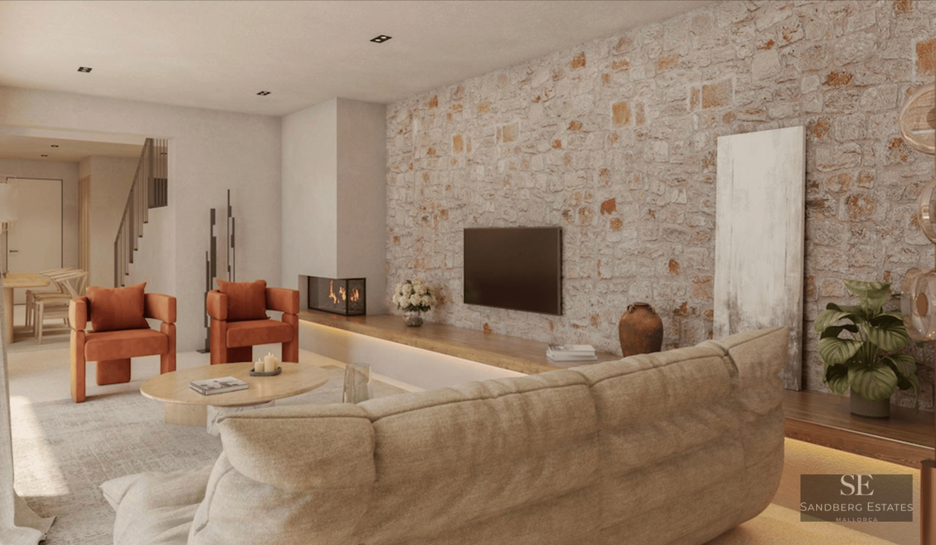 Modern living room featuring an exposed stone wall, burnt orange armchairs, a beige sofa, and a built-in fireplace.