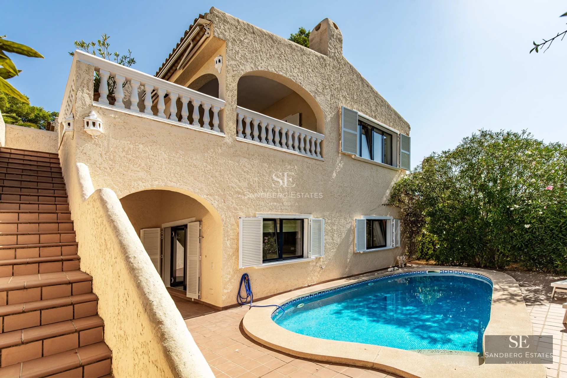 Exterior view of a luxury home featuring a pool, large garden, and modern architecture. Soft lighting, neutral color palette.