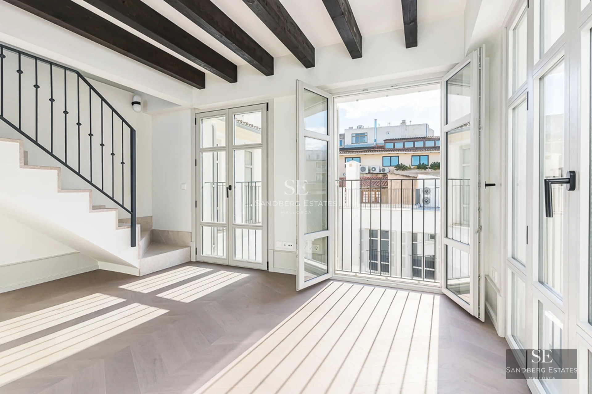 View of a luxury pool with sun loungers and umbrellas in a modern property with minimalist architecture and lush gardens.