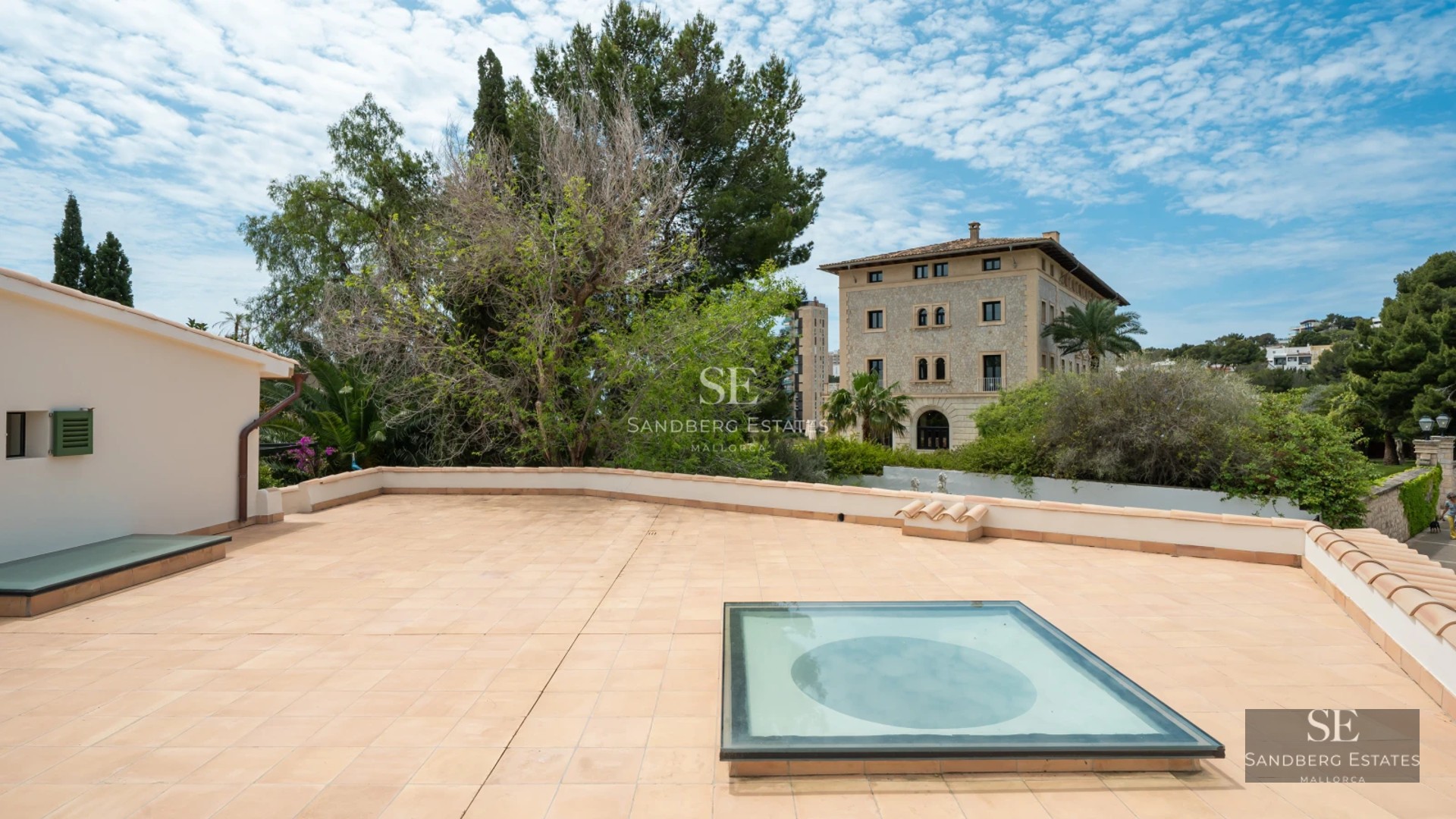 Exterior view of a modern villa featuring a reflecting pool, manicured lawn, and minimalist architectural design. Soft ambient lighting.