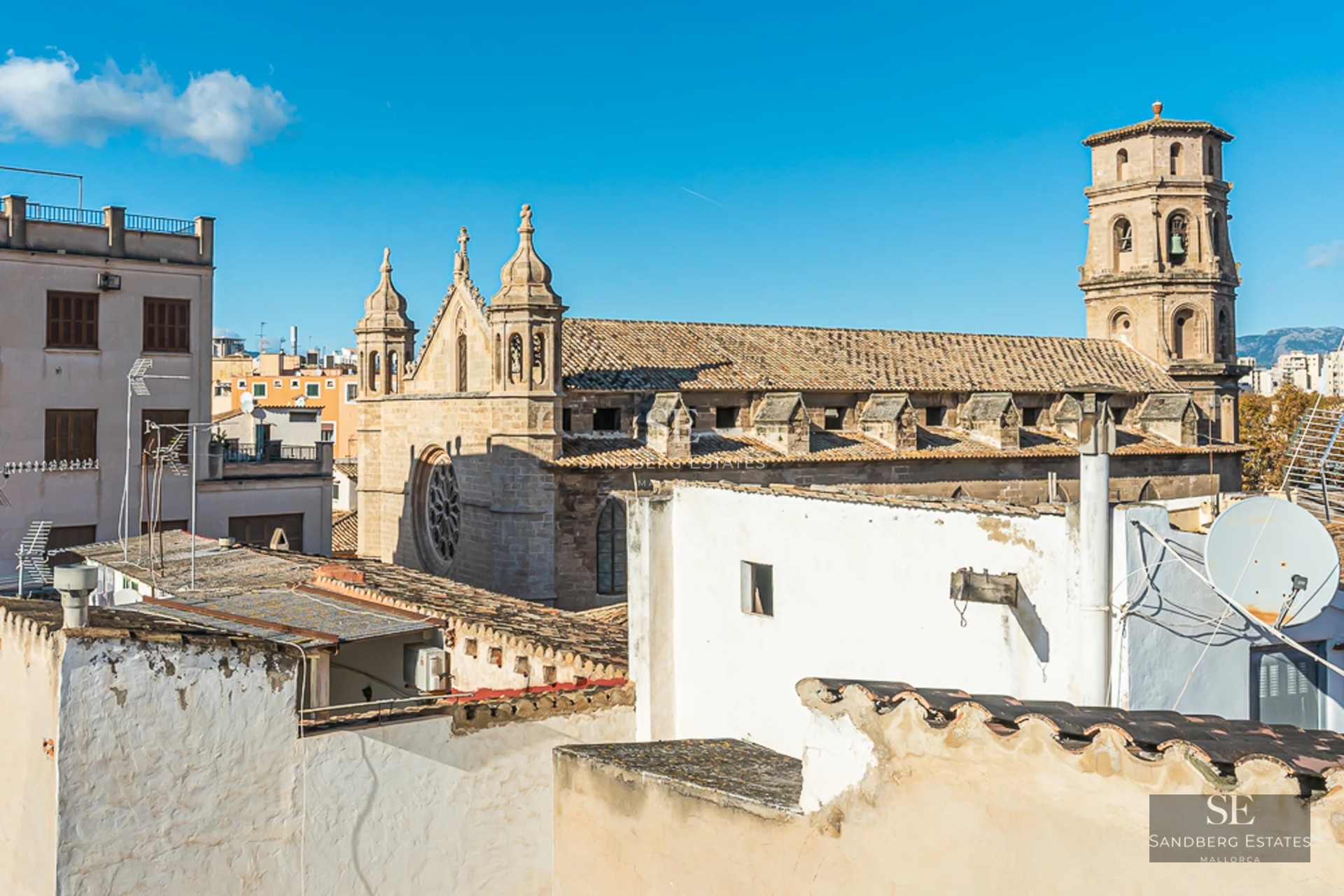 Spacious balcony with sea view from a modern apartment. Elegant furniture, glass railing, wood flooring and panoramic views.