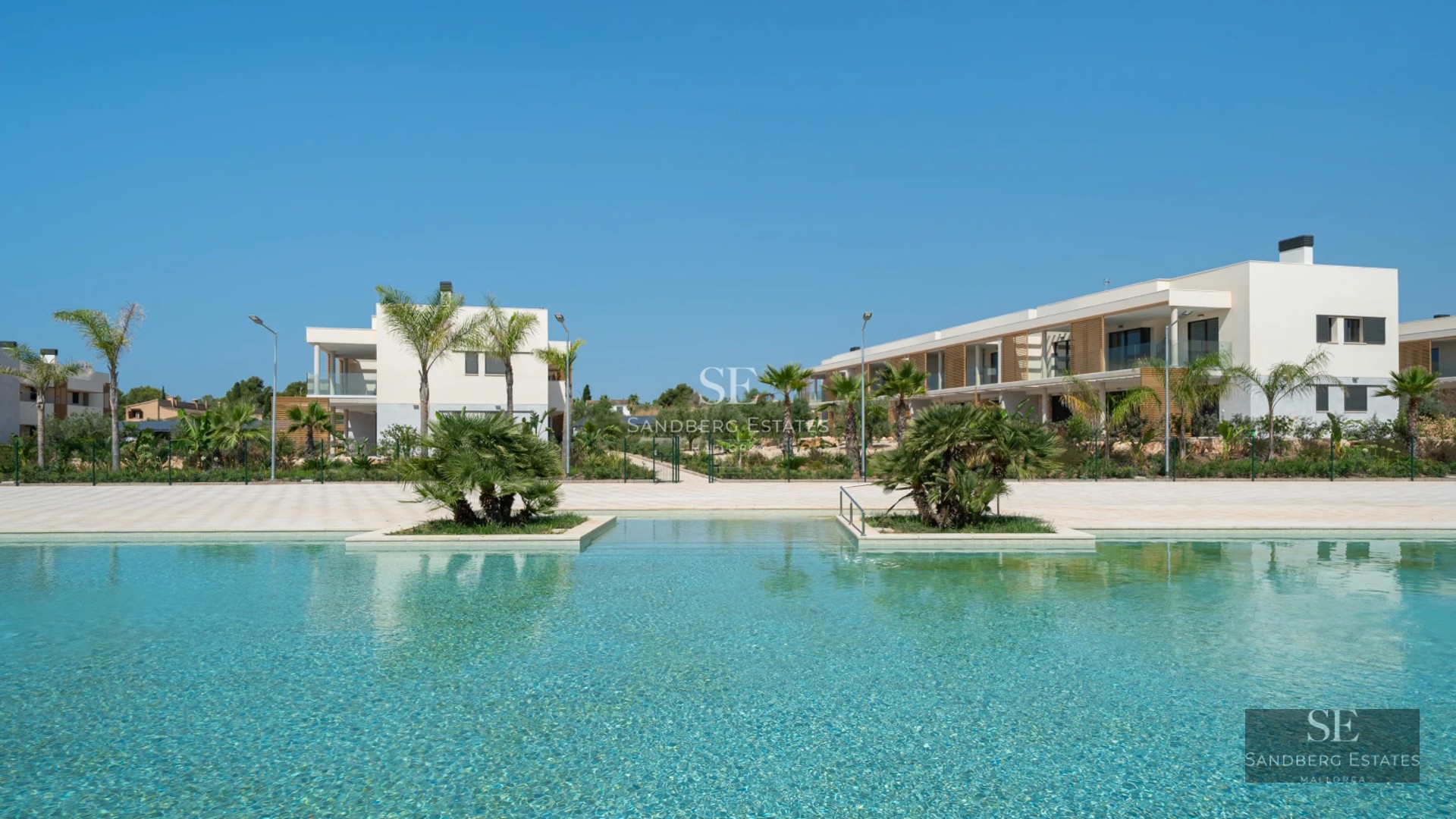 Spacious terrace with pool and lush garden. Modern architecture with large windows and stylish outdoor furniture.