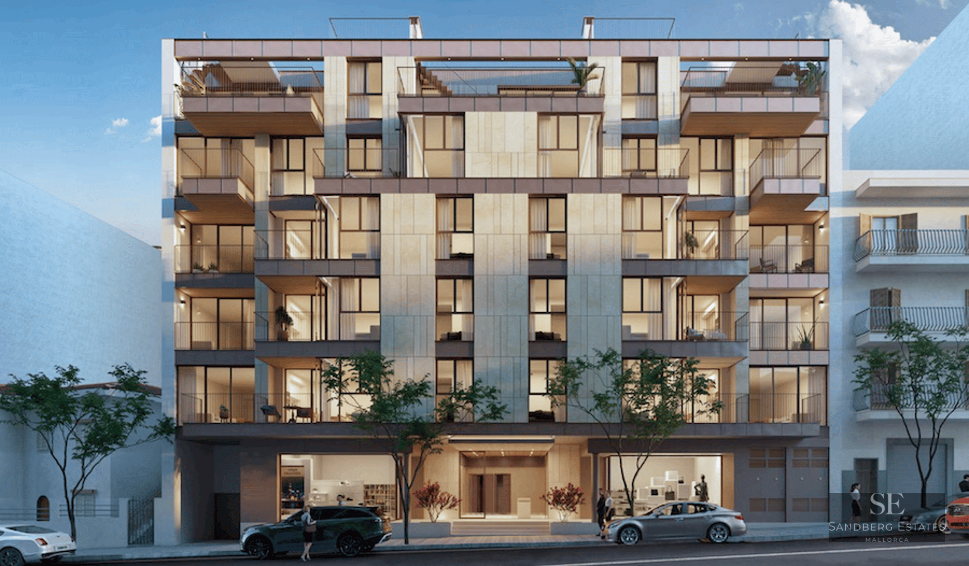 Front view of a contemporary six-story apartment building with beige stone cladding, large windows, and balconies.