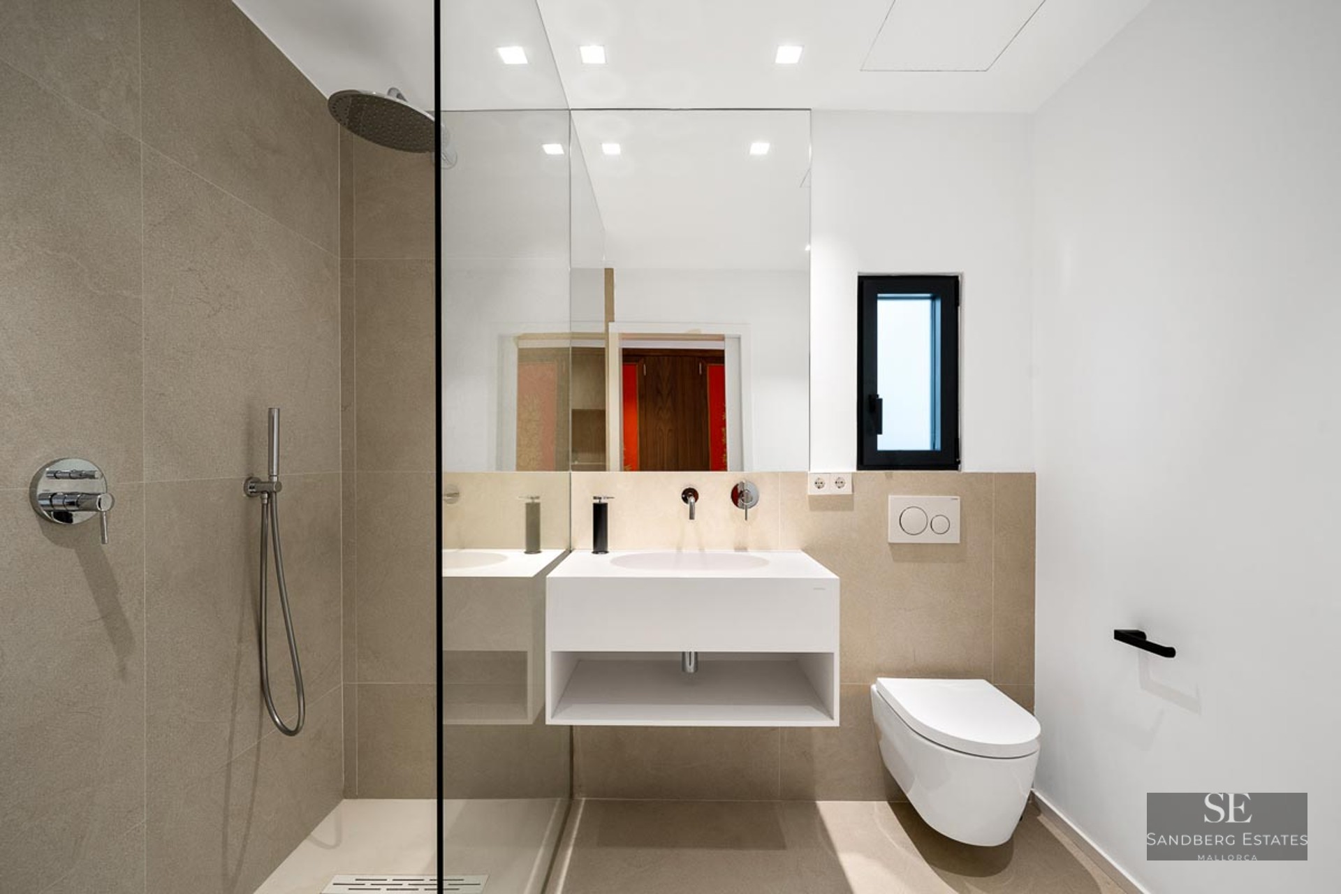 Modern bathroom featuring a glass walk-in shower, floating white vanity, and beige stone-effect tiles.