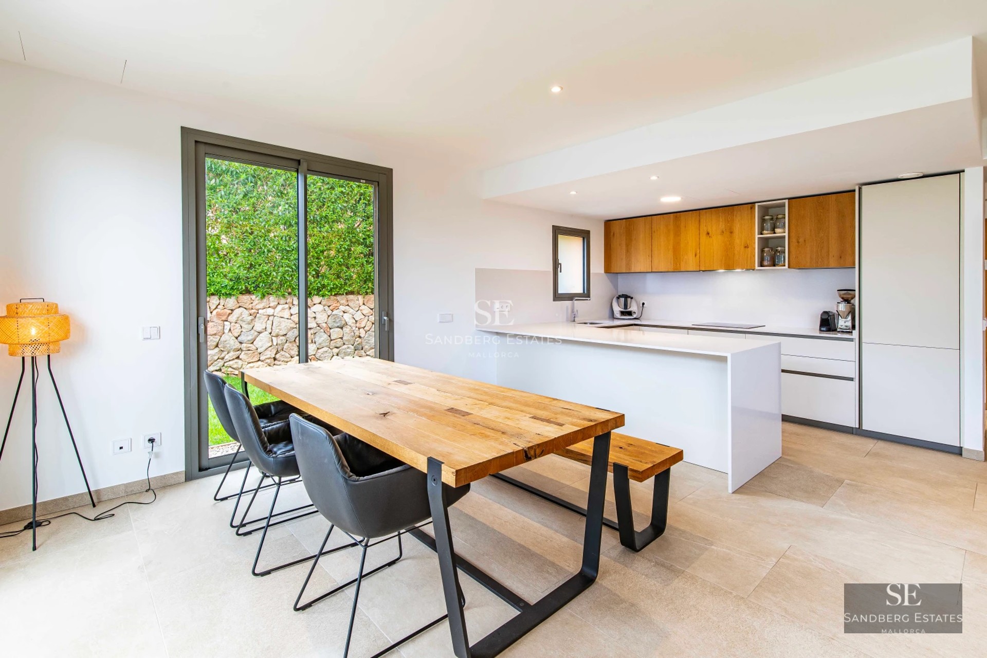 Spacious living room with panoramic sea view windows, modern and elegant decor featuring a fireplace and designer furniture.