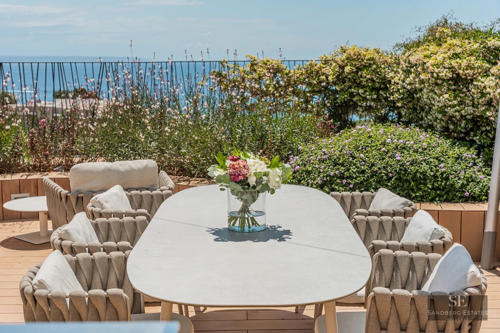 Exterior view of modern villa with reflecting pool. Minimalist architecture, large windows, and lush greenery.
