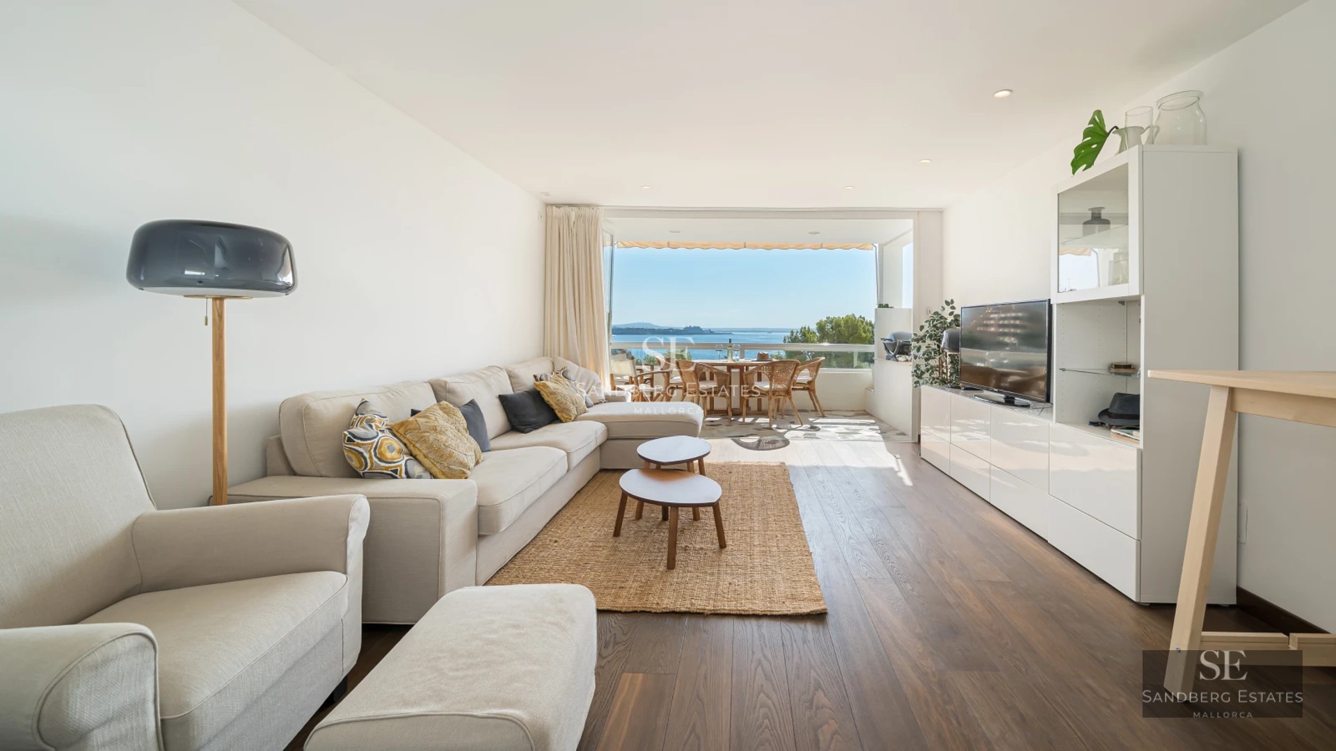 Exterior view of a modern villa featuring an infinity pool, lush garden, and spacious terraces. Minimalist architecture with large windows.