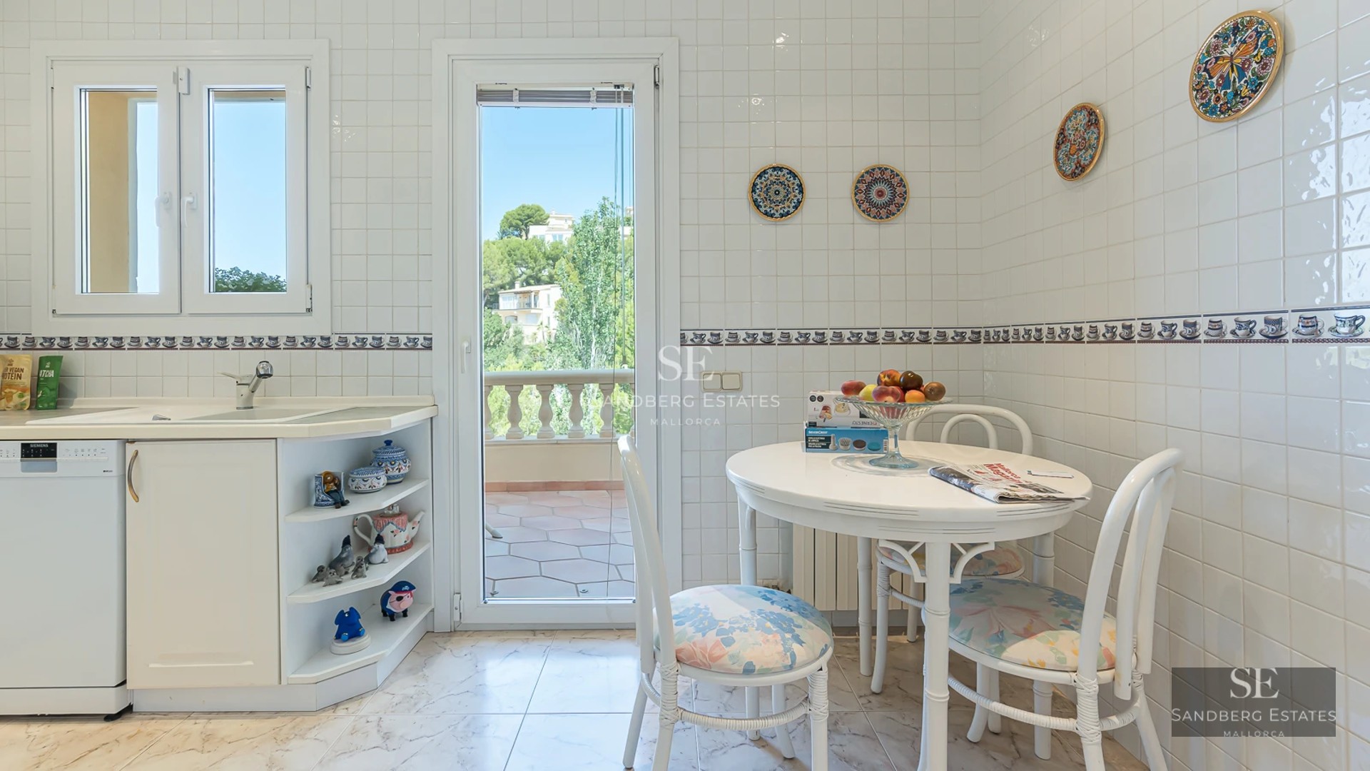 Expansive terrace with infinity pool, sun loungers, ocean views, and lush greenery. Modern design with clean lines and natural materials.