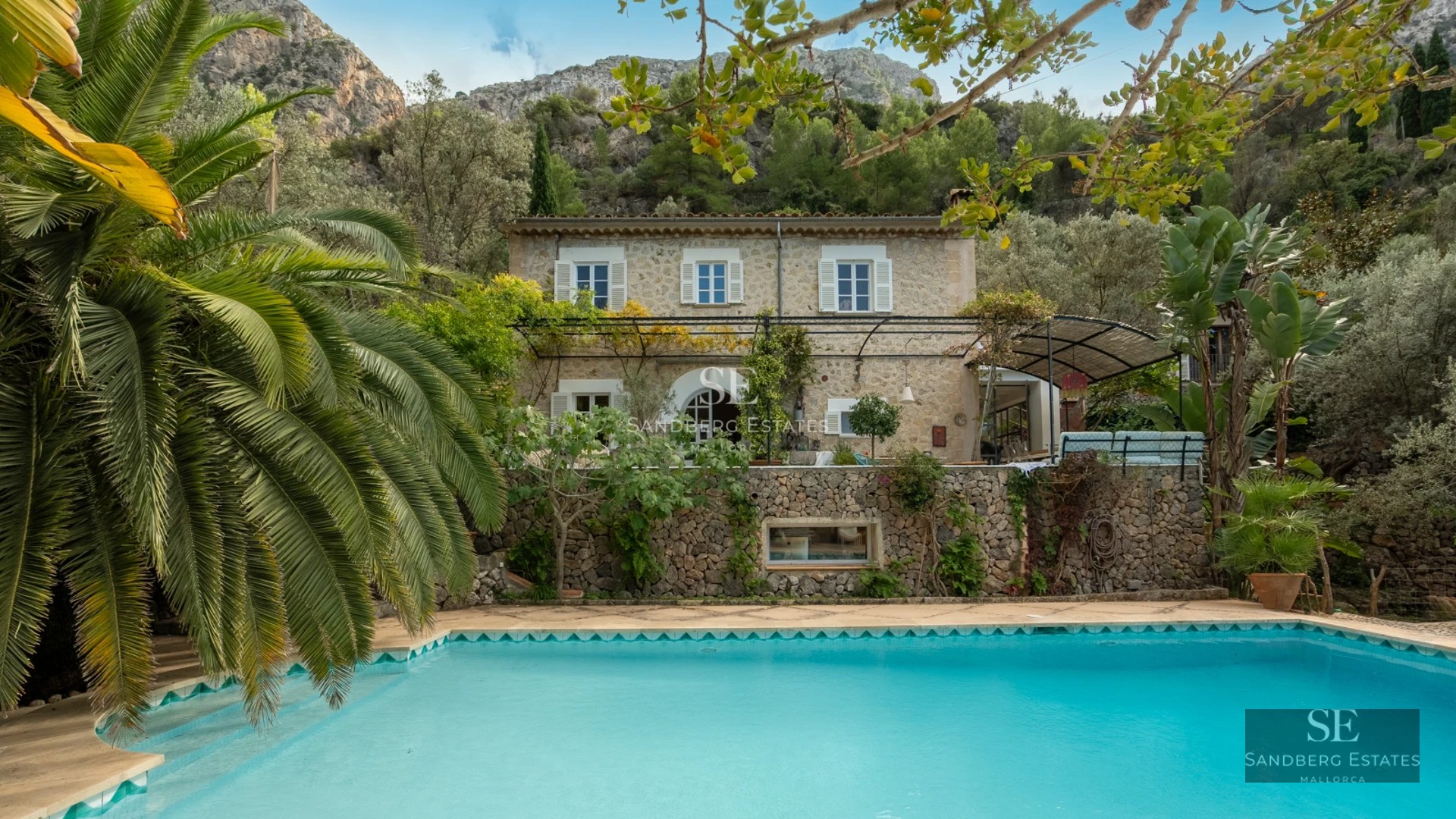 Bright living room with balcony and sea view. Modern interior with light wood floors and elegant furniture.