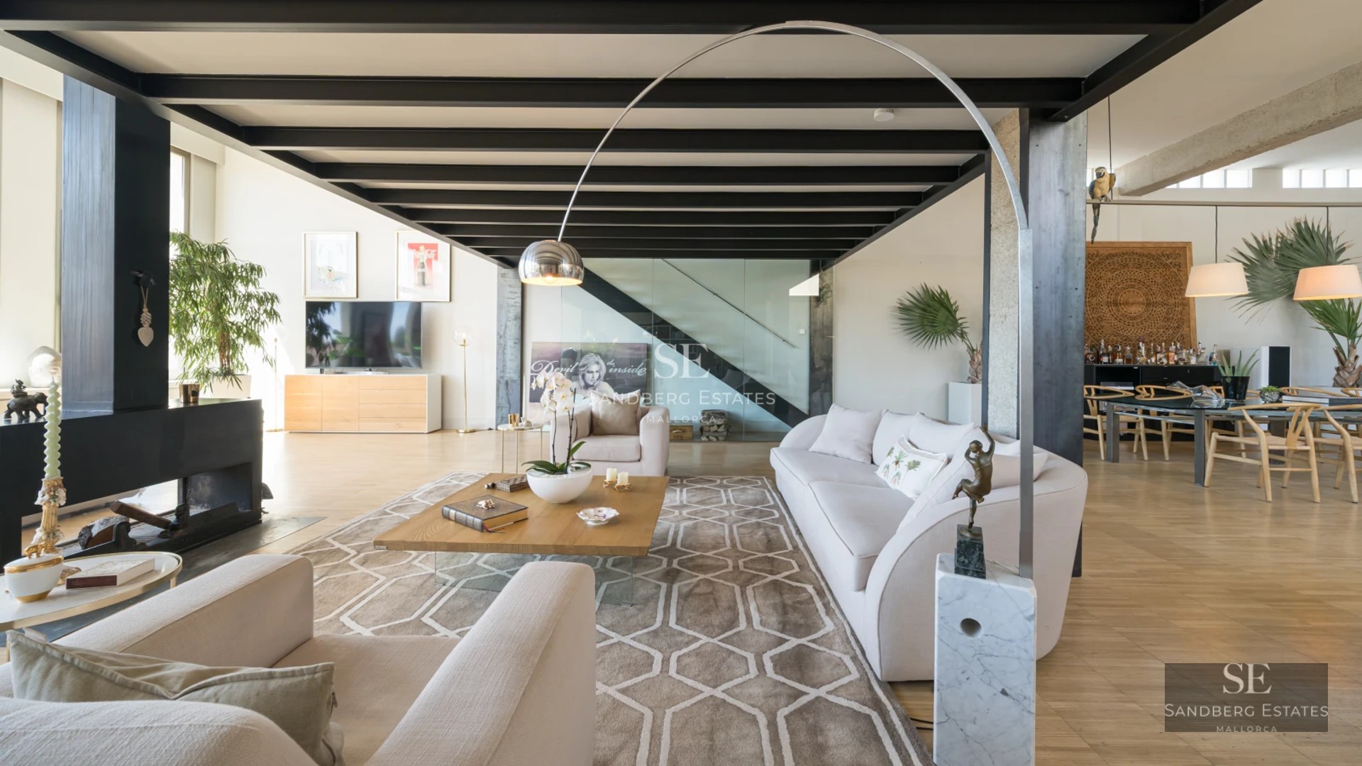 Spacious exterior with pool, lounge chairs, umbrellas, lawn, and plants. Modern and elegant design. Soft ambient lighting.