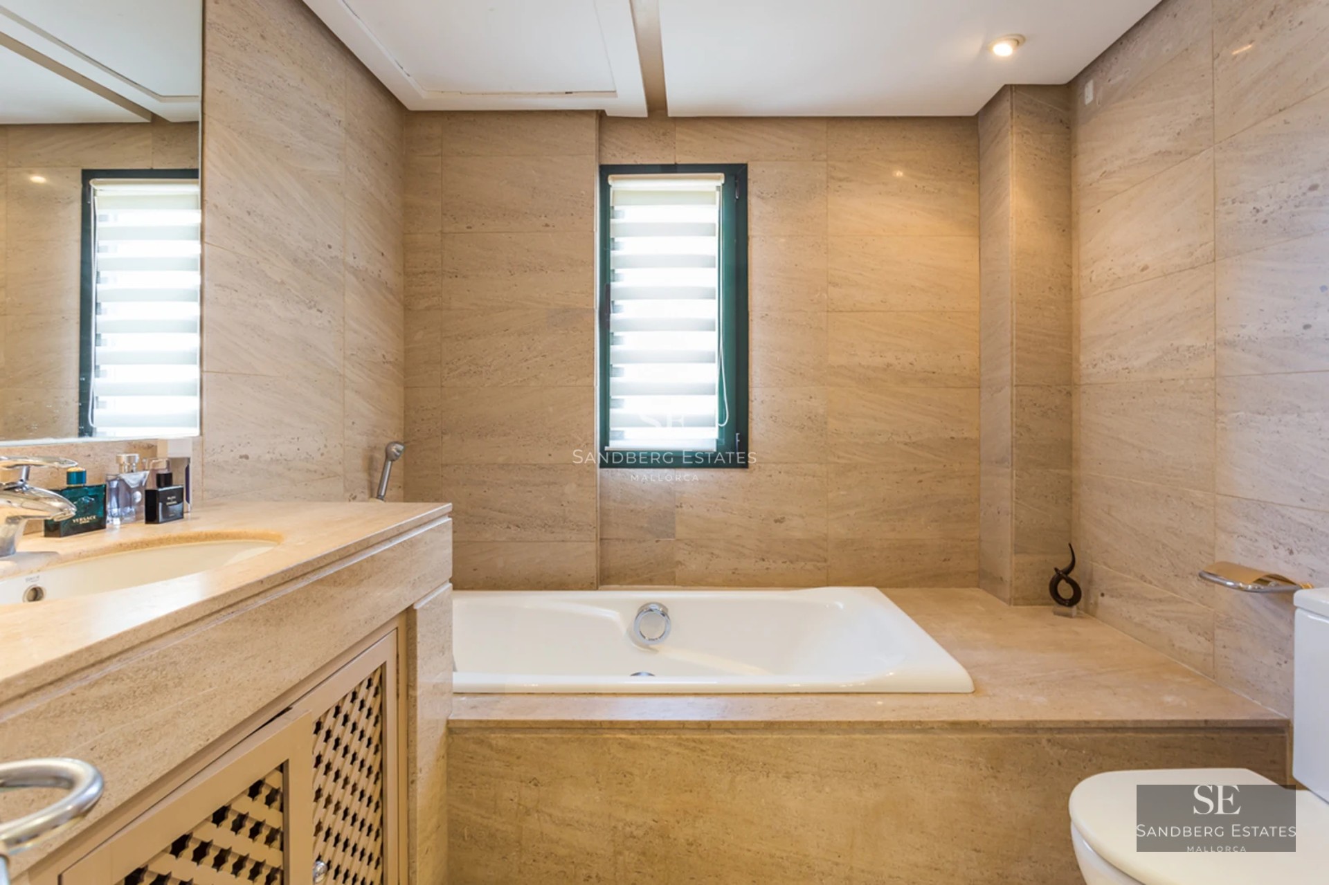 Expansive terrace with infinity pool, sun loungers, and panoramic views. Modern design with clean lines and natural materials.