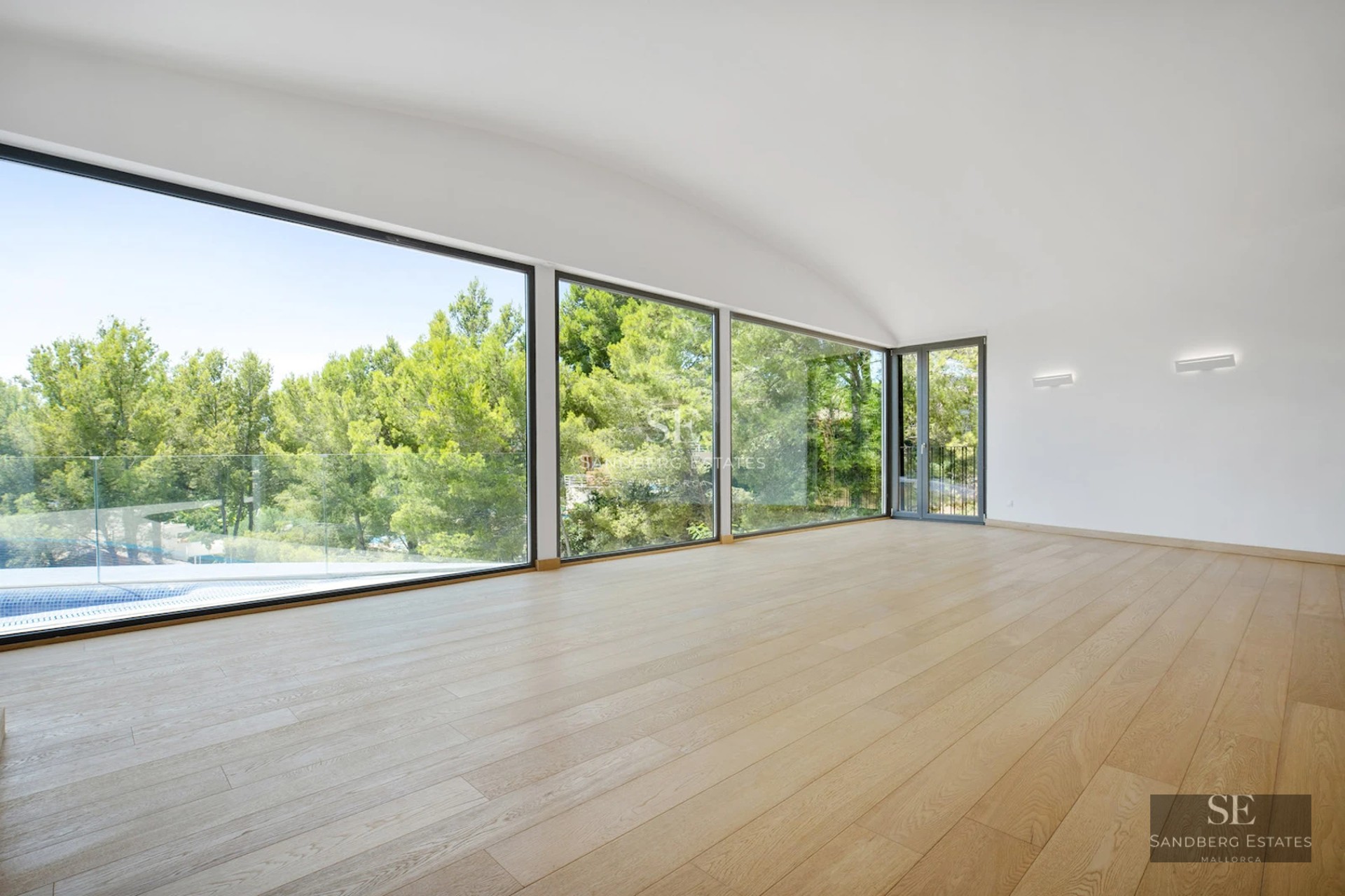 Exterior view of a modern villa with pool, terraces, and lush garden. Sleek design and expansive green spaces.