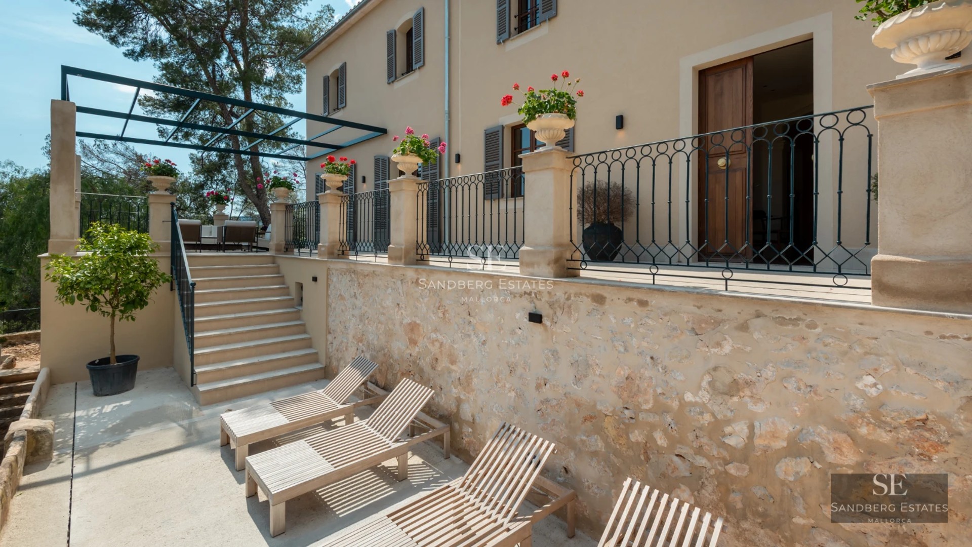 Bright living room with panoramic windows, light wood floors & modern designer furniture overlooking the Mediterranean Sea.