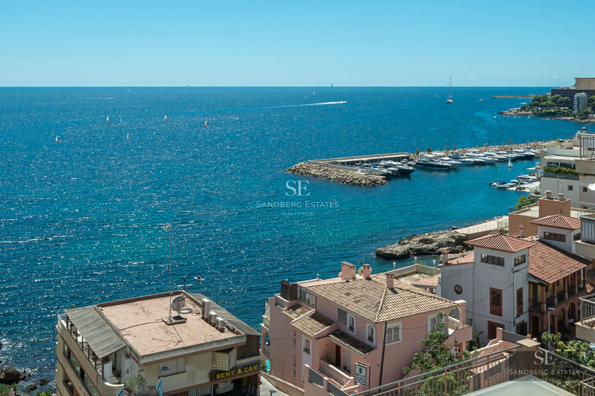 Bright living room with balcony and sea view. Designer sofa, modern coffee table, minimalist decor. Large windows and natural light.