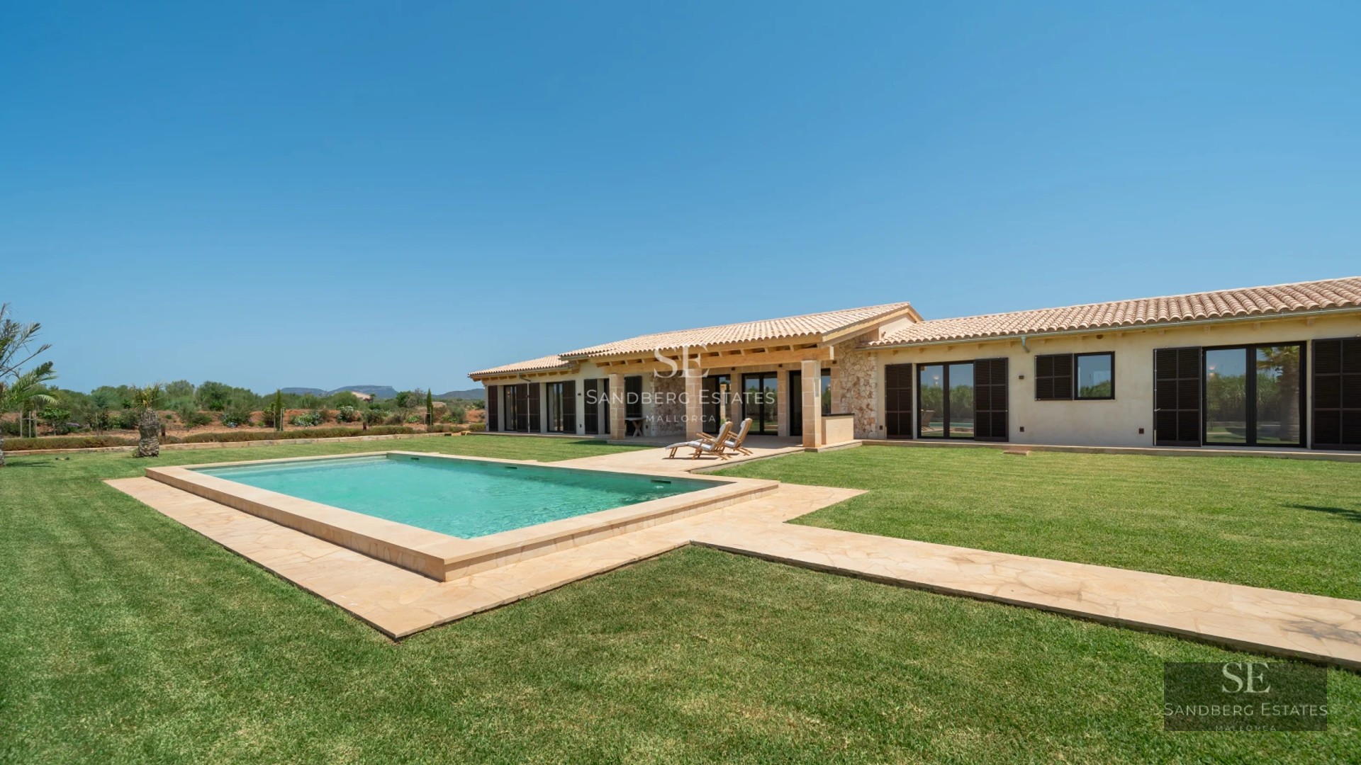 Spacious living room with panoramic sea views. Leather sofas, designer rug, warm lighting, and luxurious details.