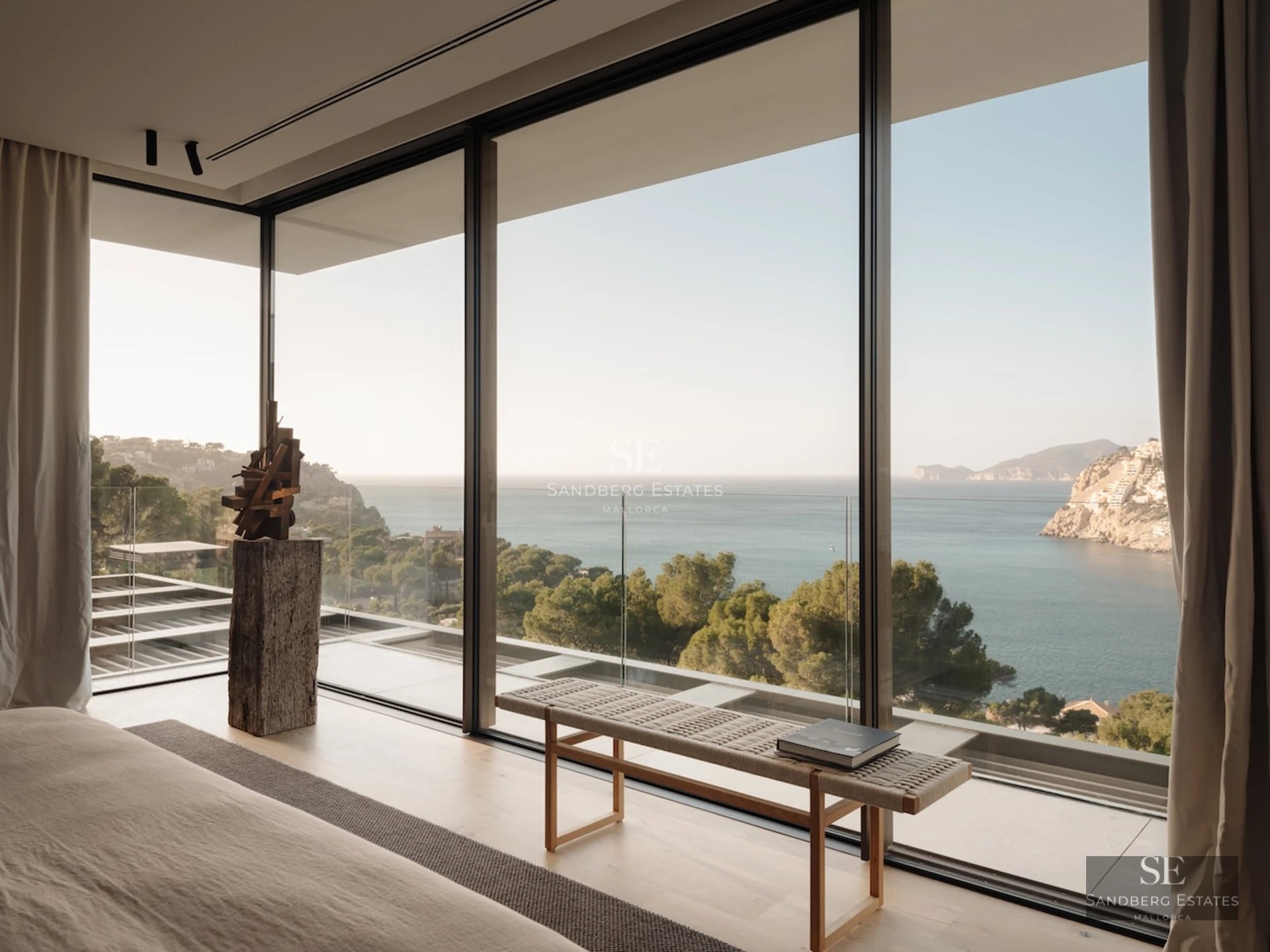 Expansive terrace with infinity pool and sea views. Modern, minimalist design, elegant and relaxing outdoor furniture.