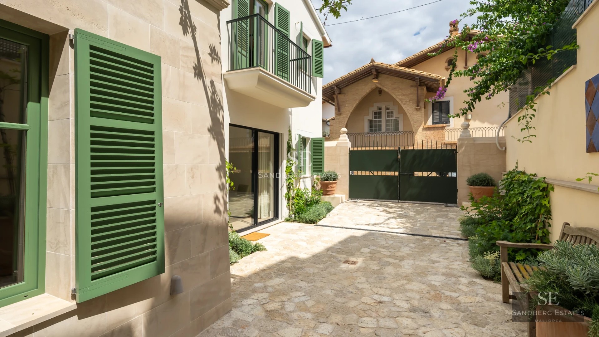 Exterior view of a modern villa featuring an infinity pool, wooden deck, and lush garden. Contemporary architecture and landscape design.