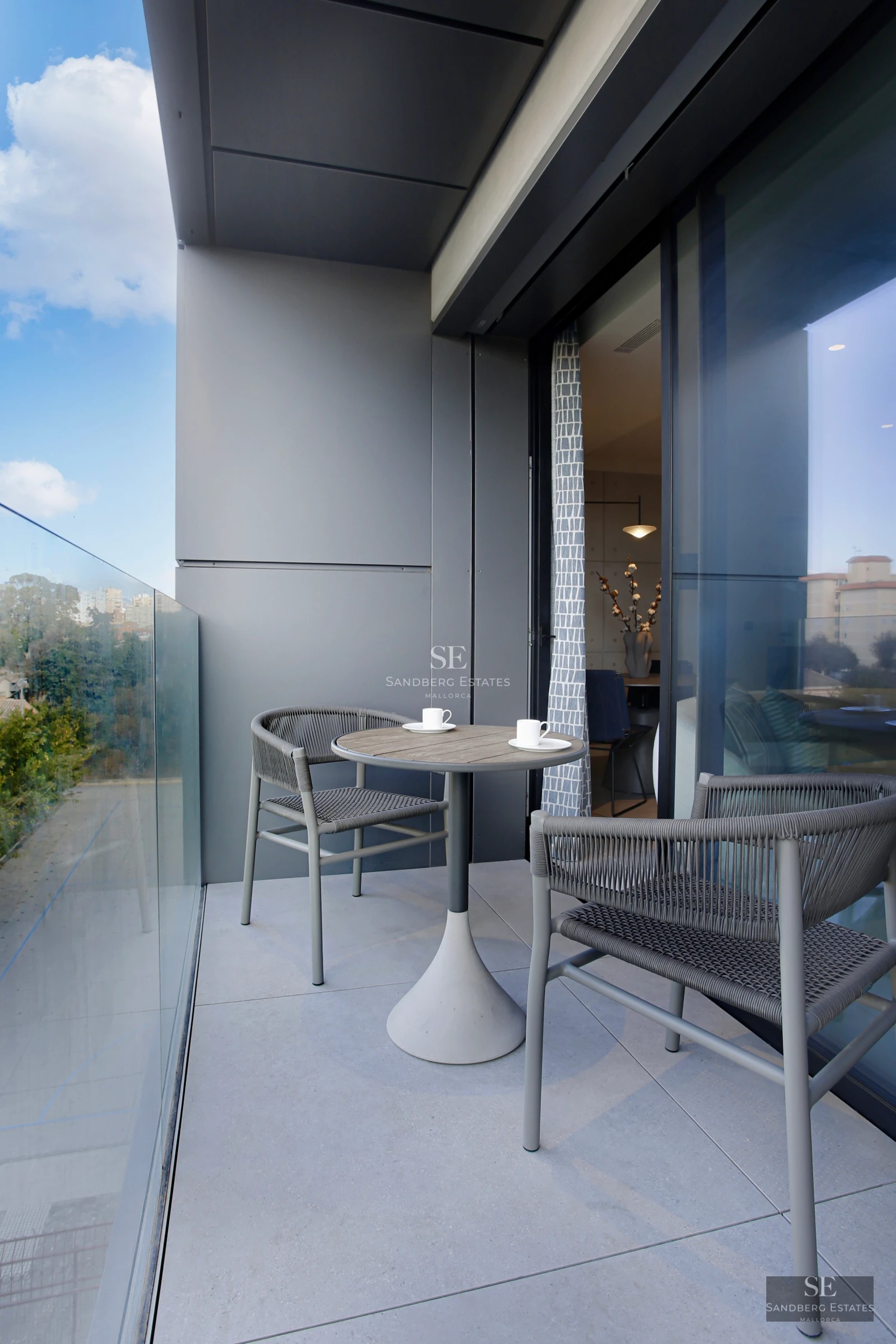 Exterior view of a modern villa with a pool, manicured gardens and minimalist architecture. White facade and large windows.