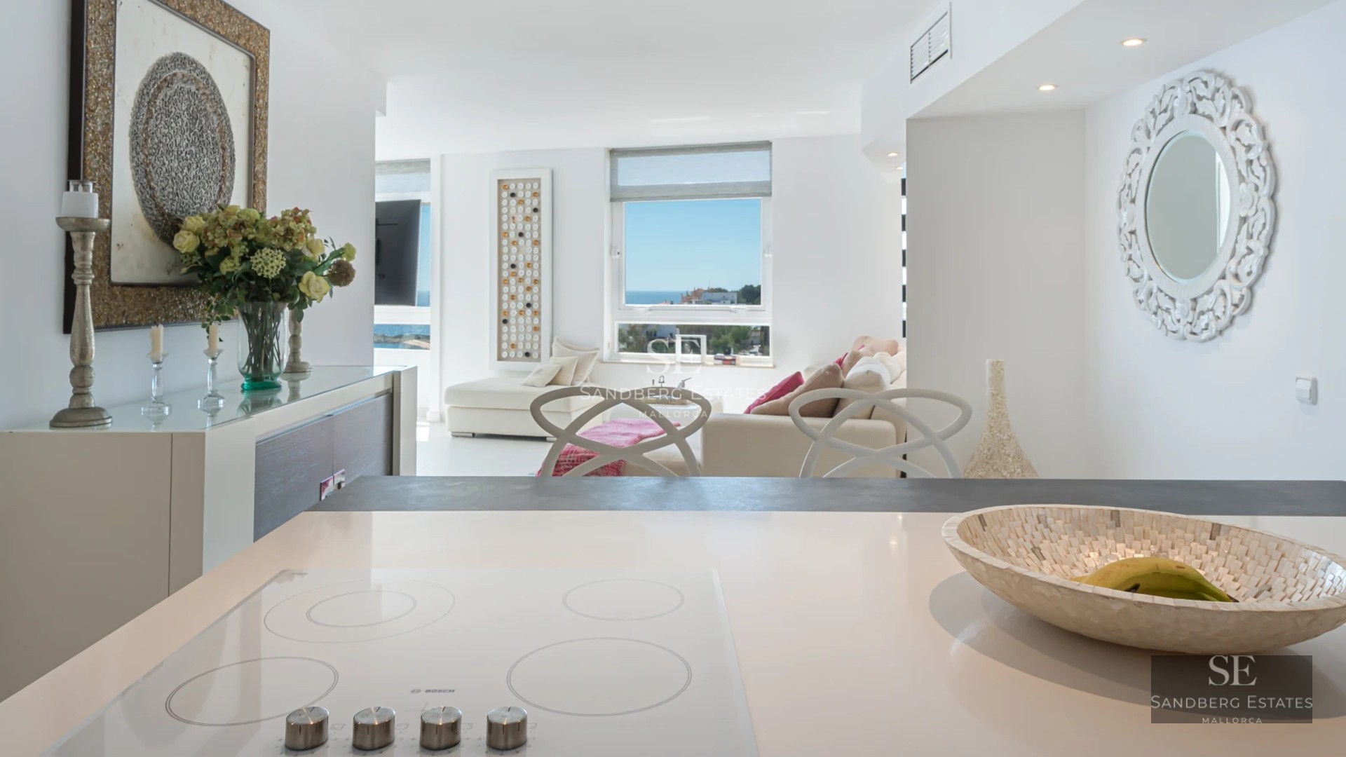 Contemporary design villa featuring an infinity pool, spacious terraces, lush vegetation, and panoramic sea views.