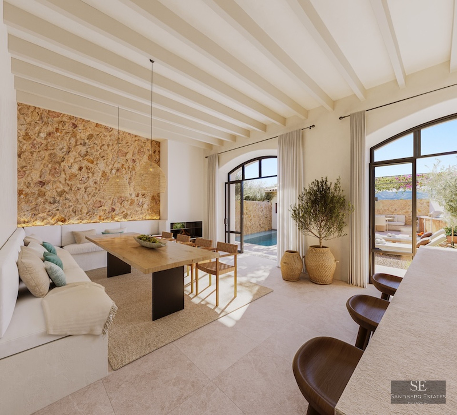 Elegant dining area featuring a natural stone wall, wooden beams, and large arched doors opening to a swimming pool.