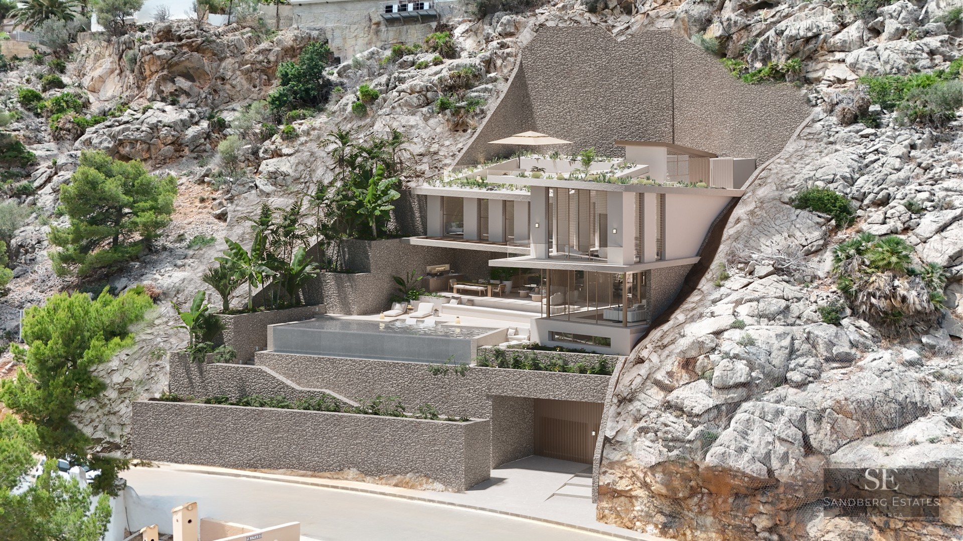 Modern multi-level villa built into a rocky cliff with an infinity pool, glass walls, and lush tropical greenery.
