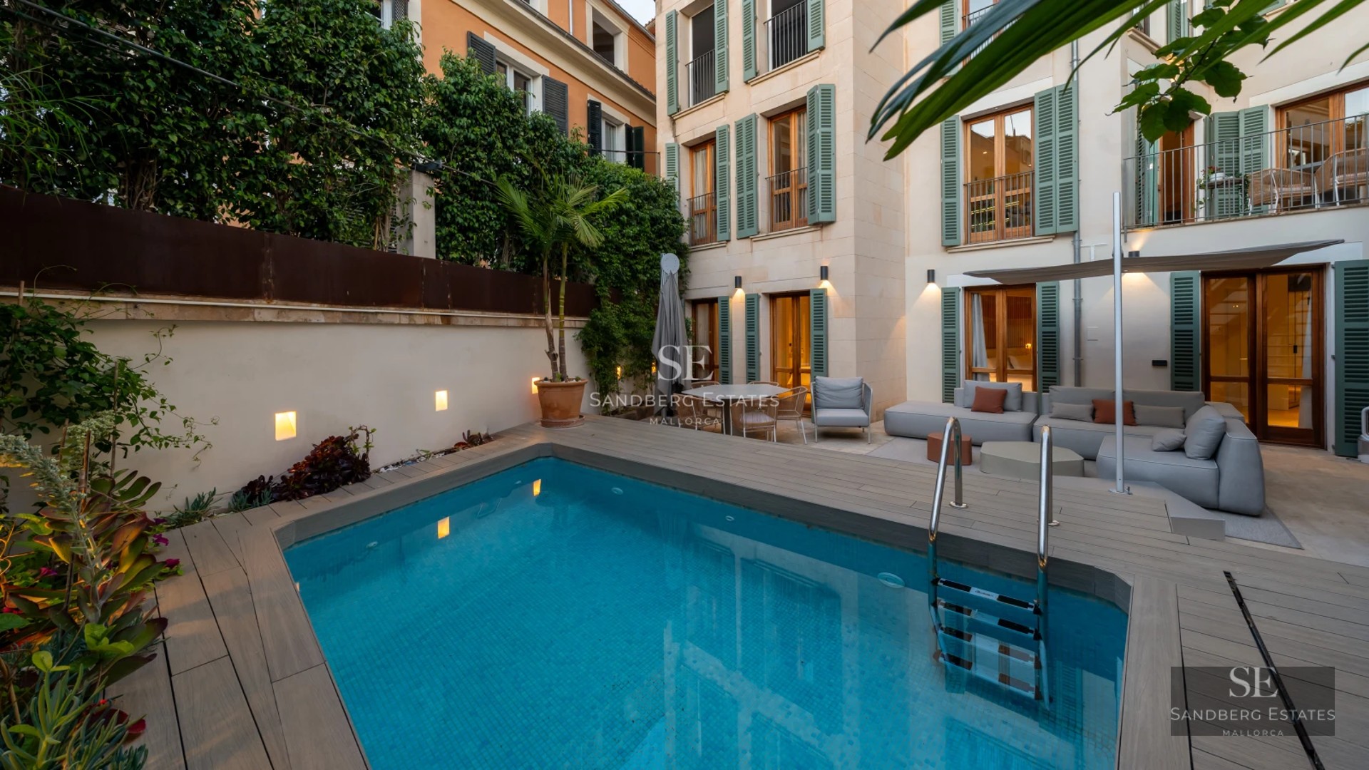 Large pool with sun loungers and open views. Modern, minimalist architecture. Perfect for relaxing and enjoying the sun.