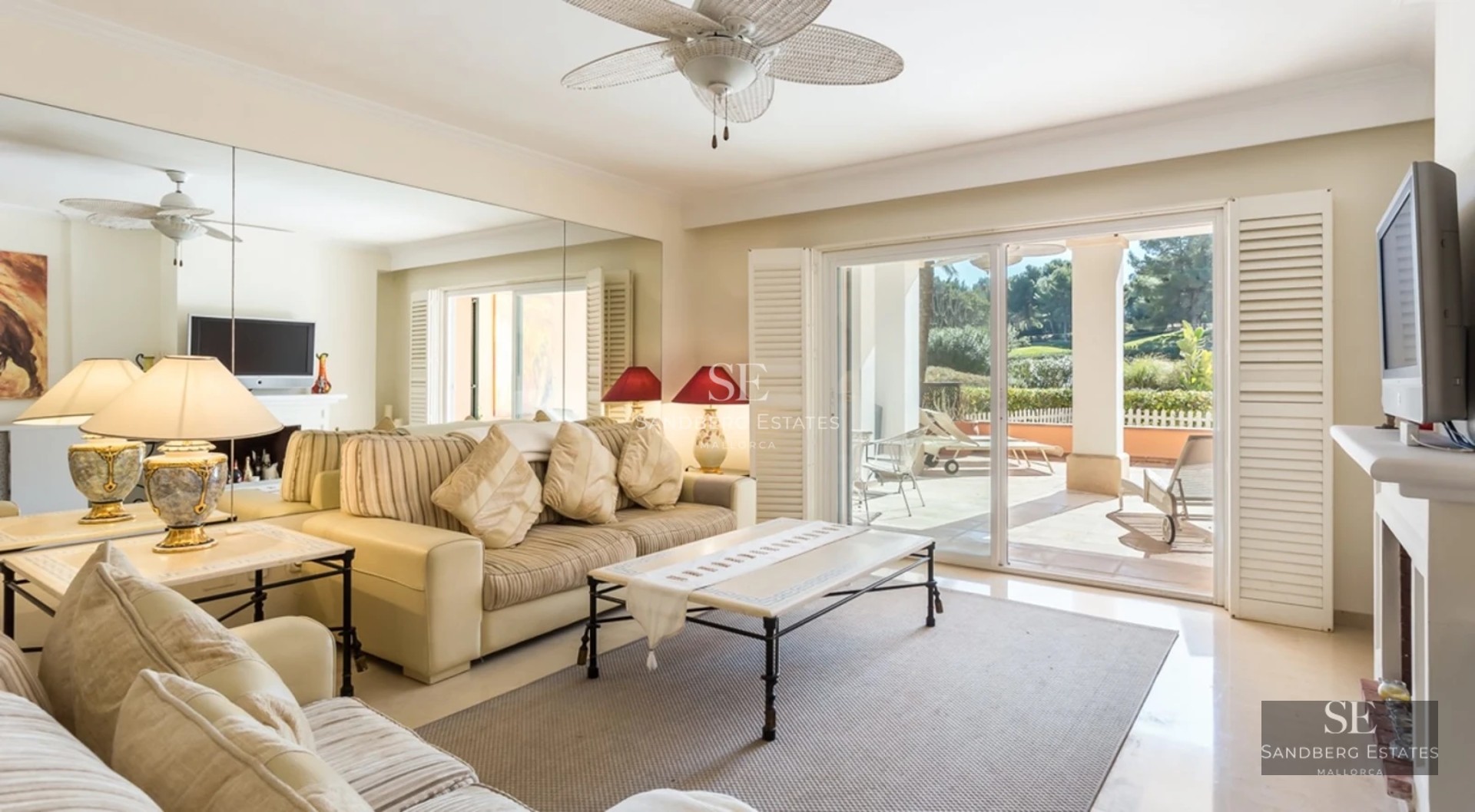 Spacious balcony with sea view, glass railing, wooden floor, outdoor seating area. Modern and elegant design.