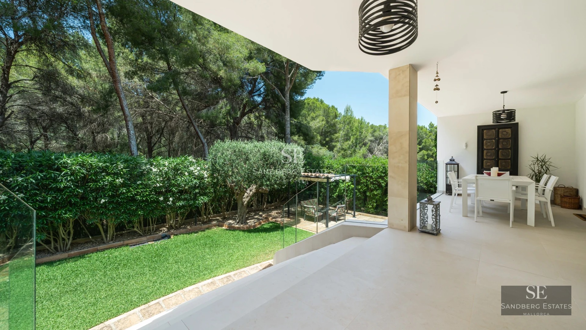 Spacious, bright living room with large windows and panoramic sea views. Modern sofa and elegant decor.