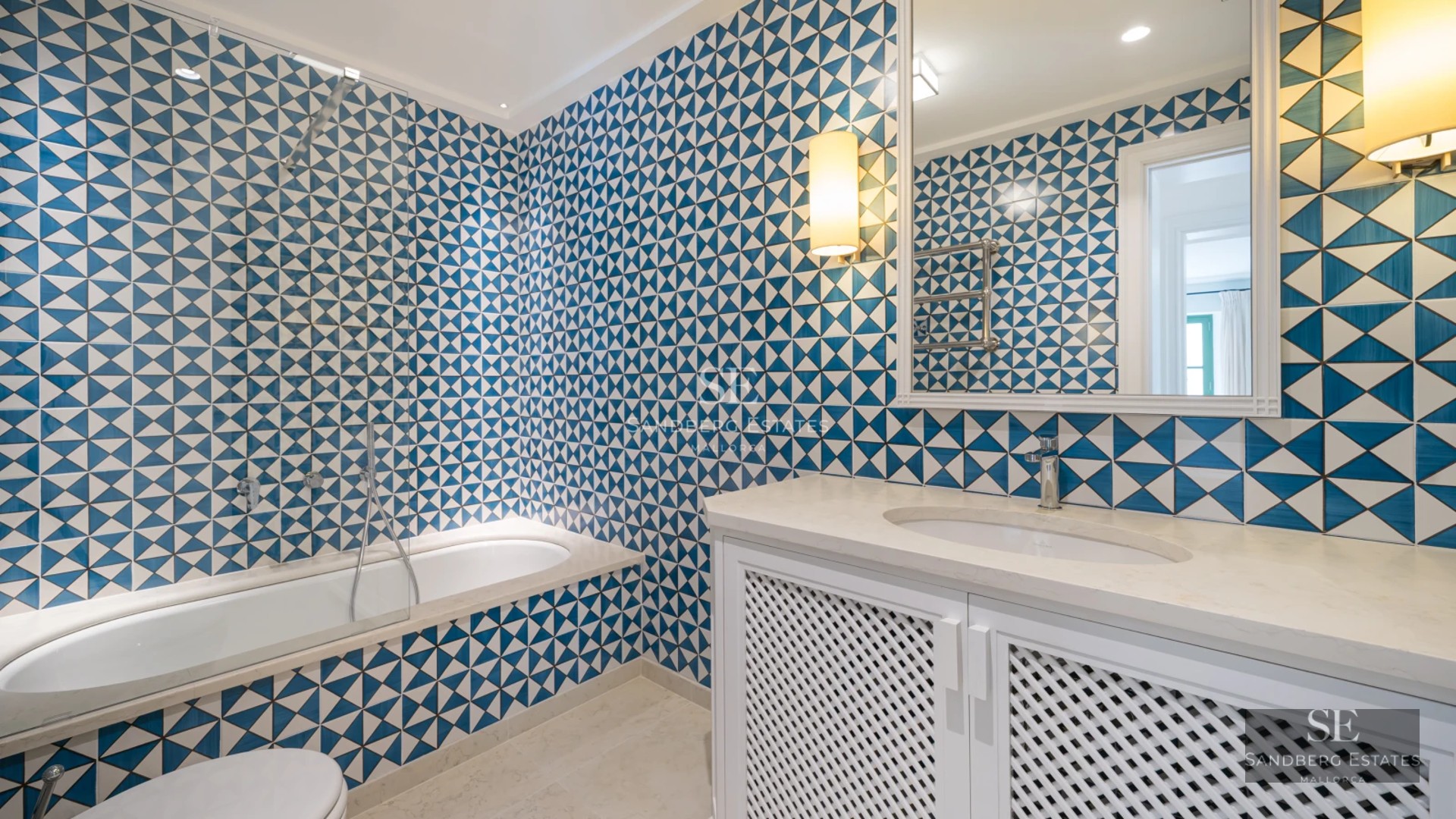 Expansive terrace featuring an infinity pool and sea views. Modern furniture, sun loungers and parasols. Elegant and relaxing design.