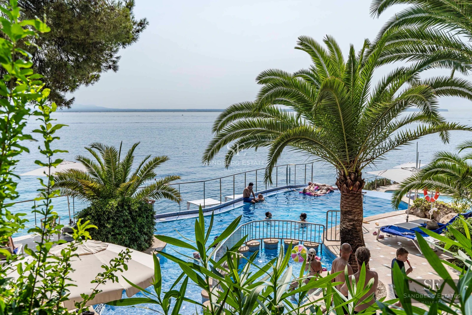 Exterior view of a modern villa with pool, landscaped garden, large windows, and minimalist design. Ambient lighting.