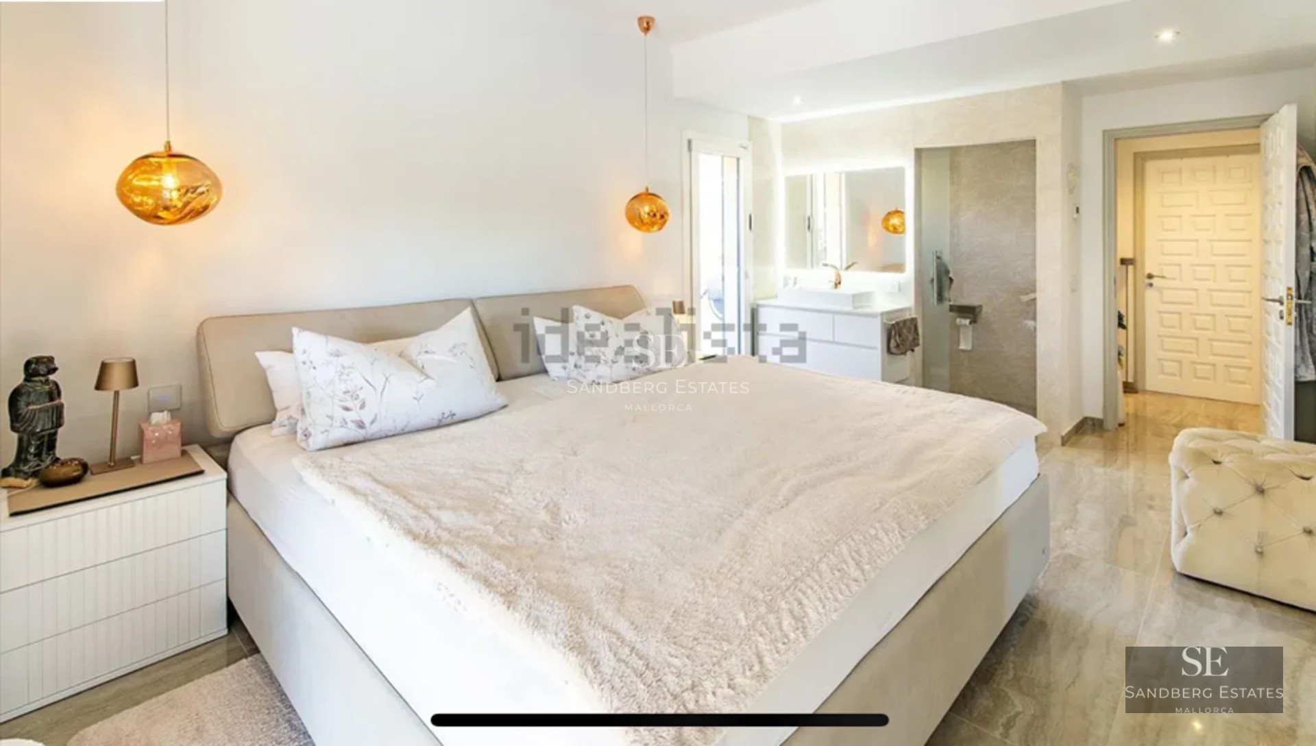 Bright living room with large windows, modern sofa, designer rug, and panoramic sea views. Elegant and minimalist decor.