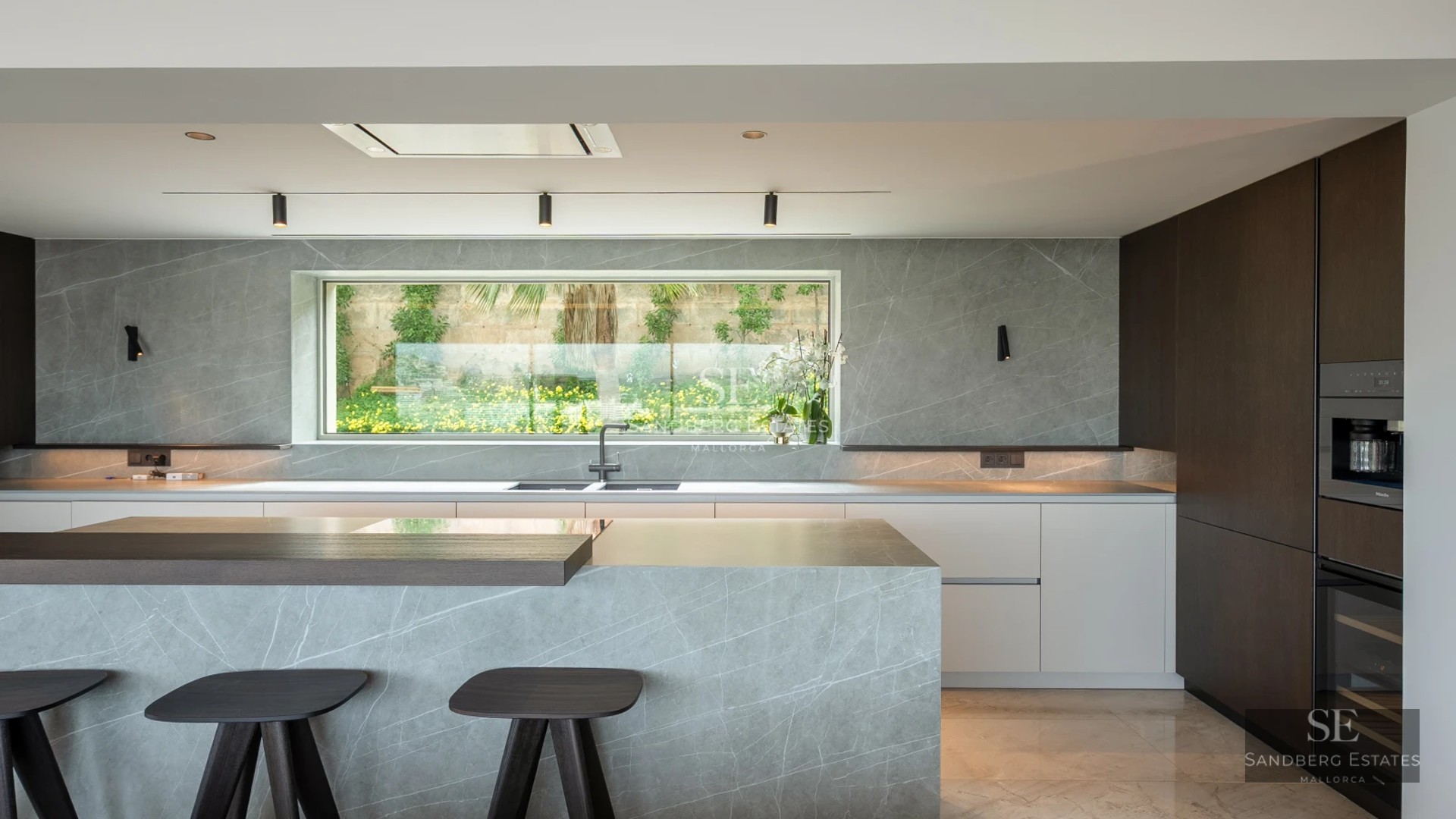 View of a luxurious villa with a pool. Modern design, large windows, lush garden and elegant outdoor furniture.