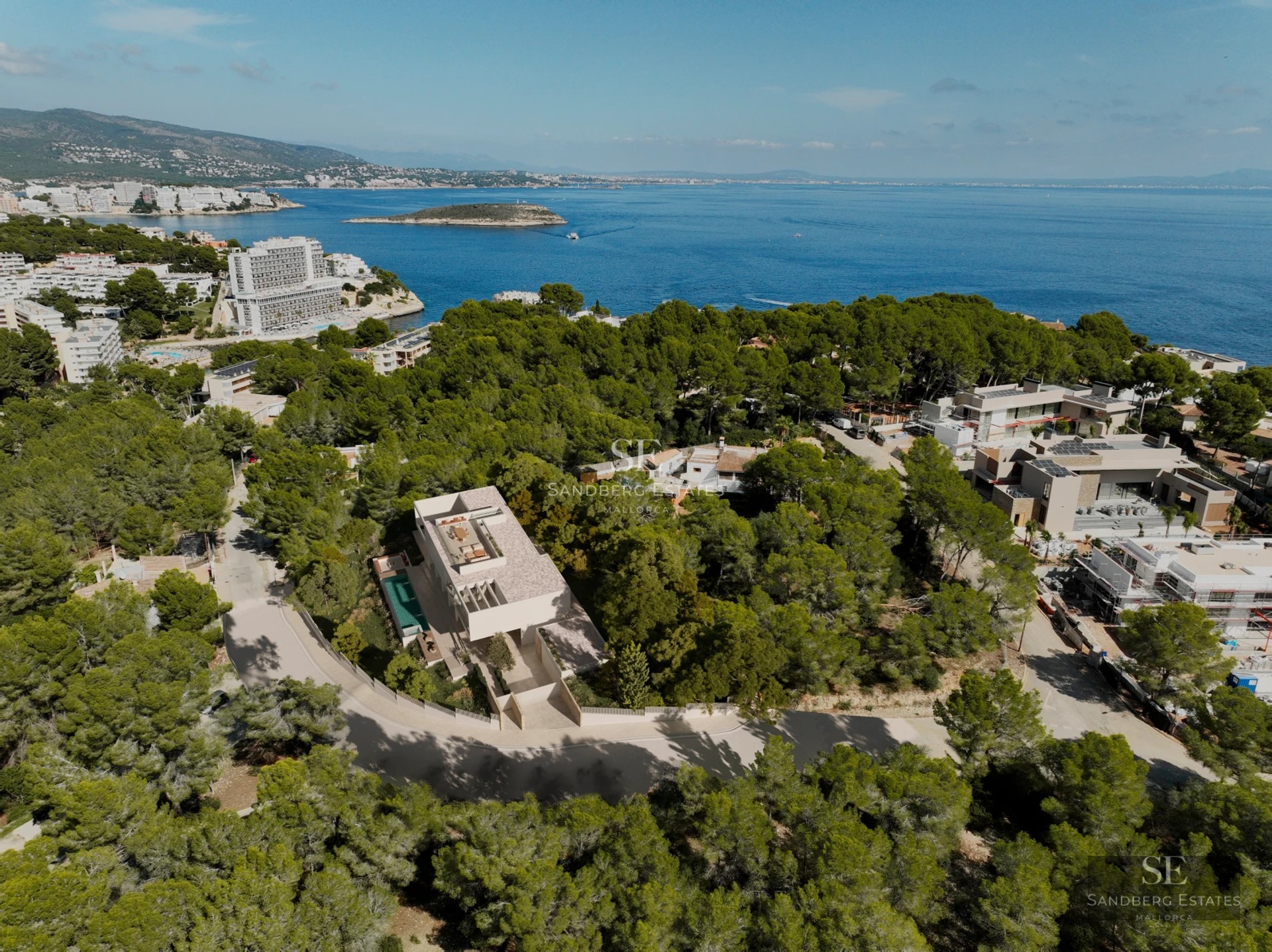 Spacious terrace with infinity pool, sun loungers, and panoramic sea views. Modern design featuring ambient lighting and lush vegetation.