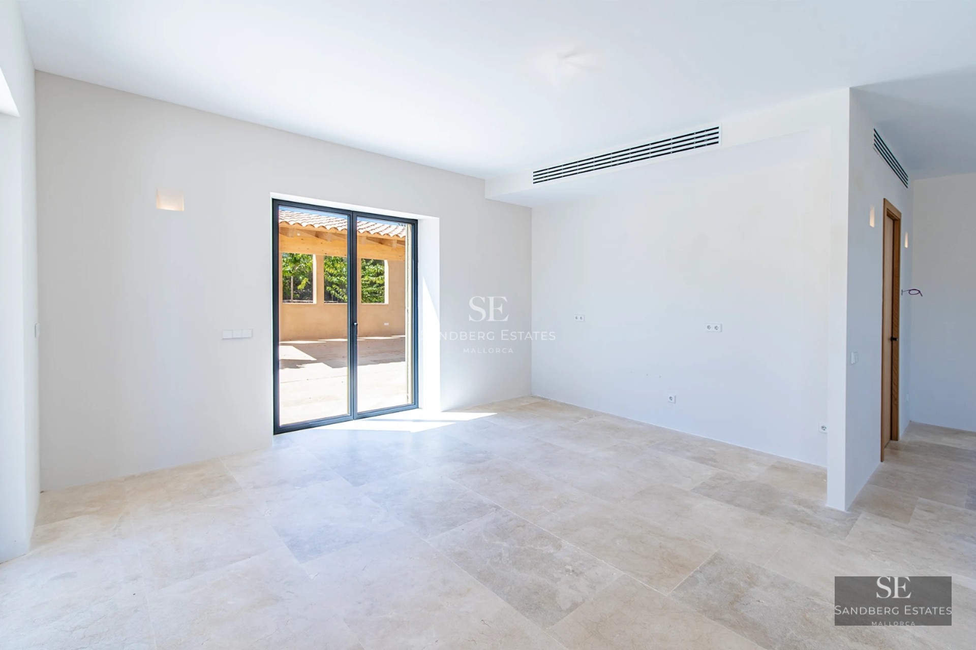 Exterior view of modern villa with infinity pool, lounge chairs, and seating area. Minimalist and elegant design with lush vegetation.