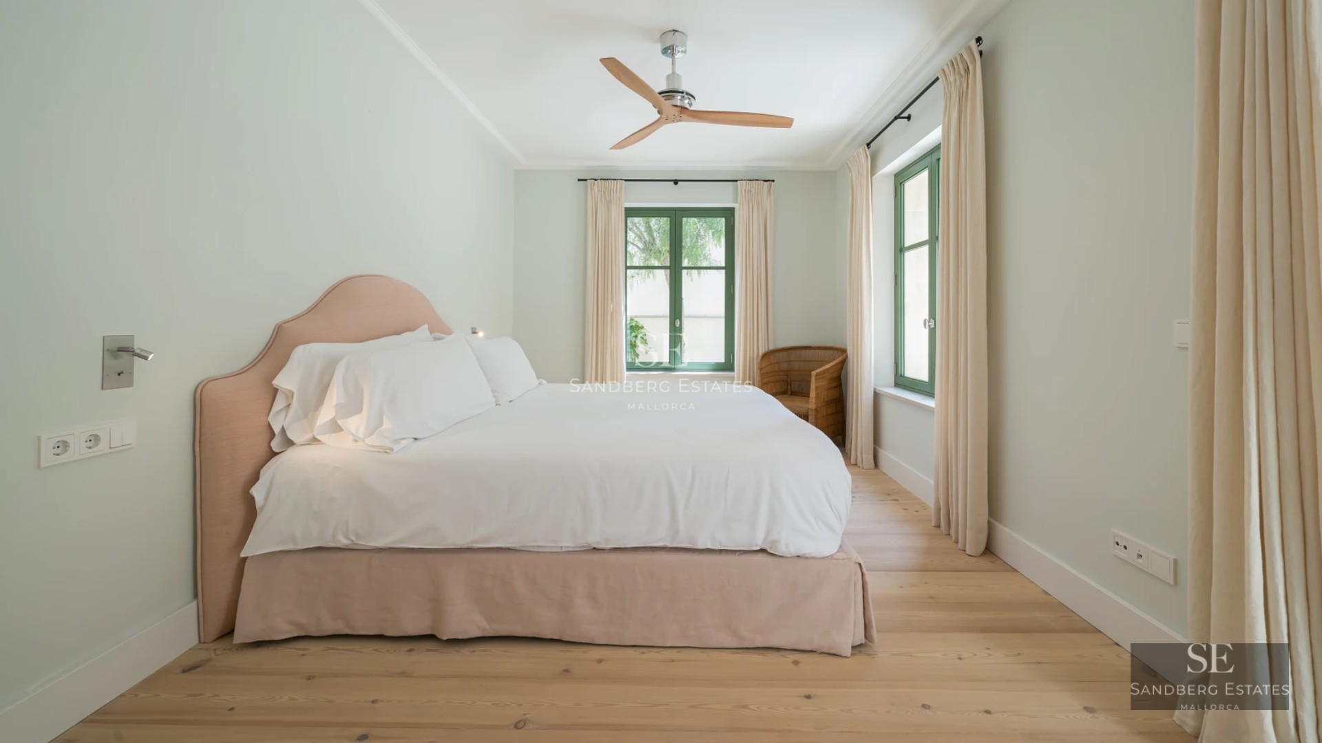 Exterior view of modern villa with infinity pool, spacious terraces, lush garden, and contemporary architecture.