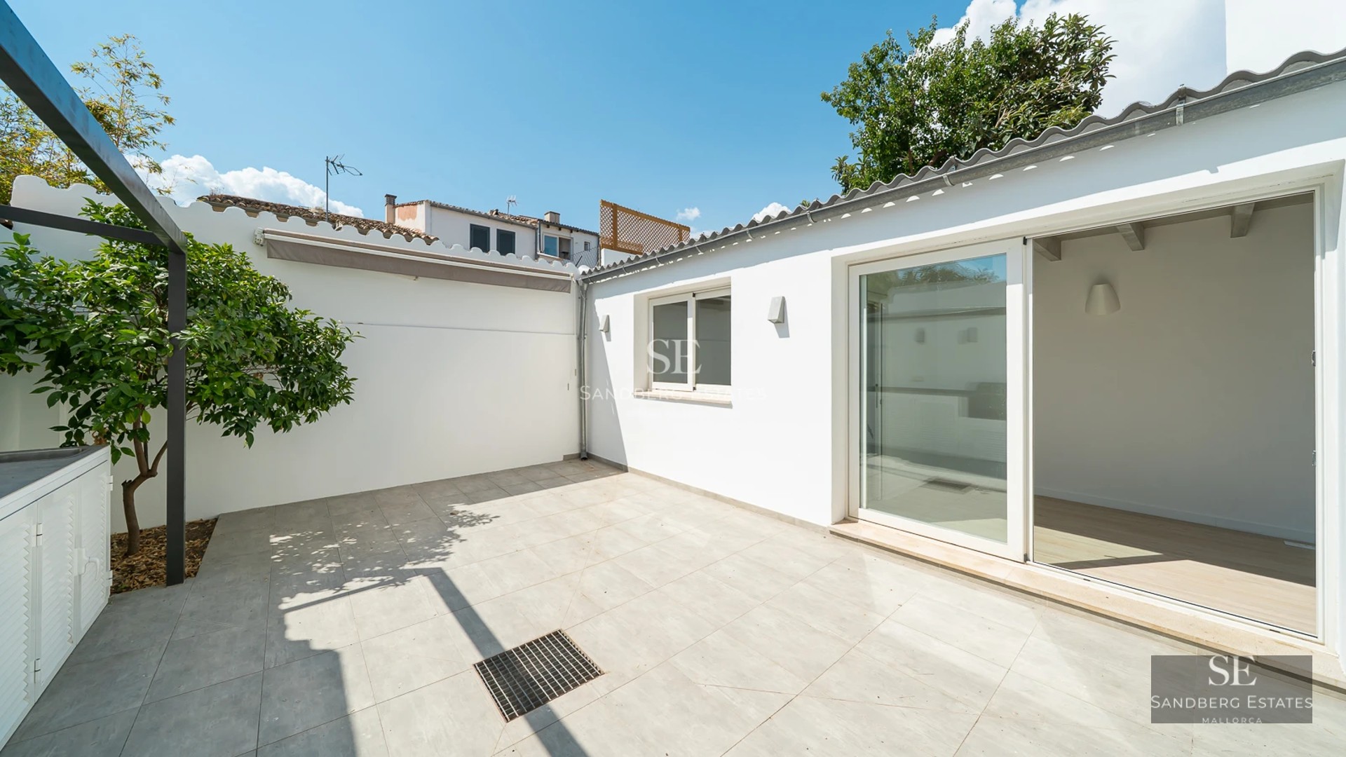 View of a modern villa featuring an infinity pool, sun loungers, and expansive garden. Minimalist architecture, perfect for relaxation.