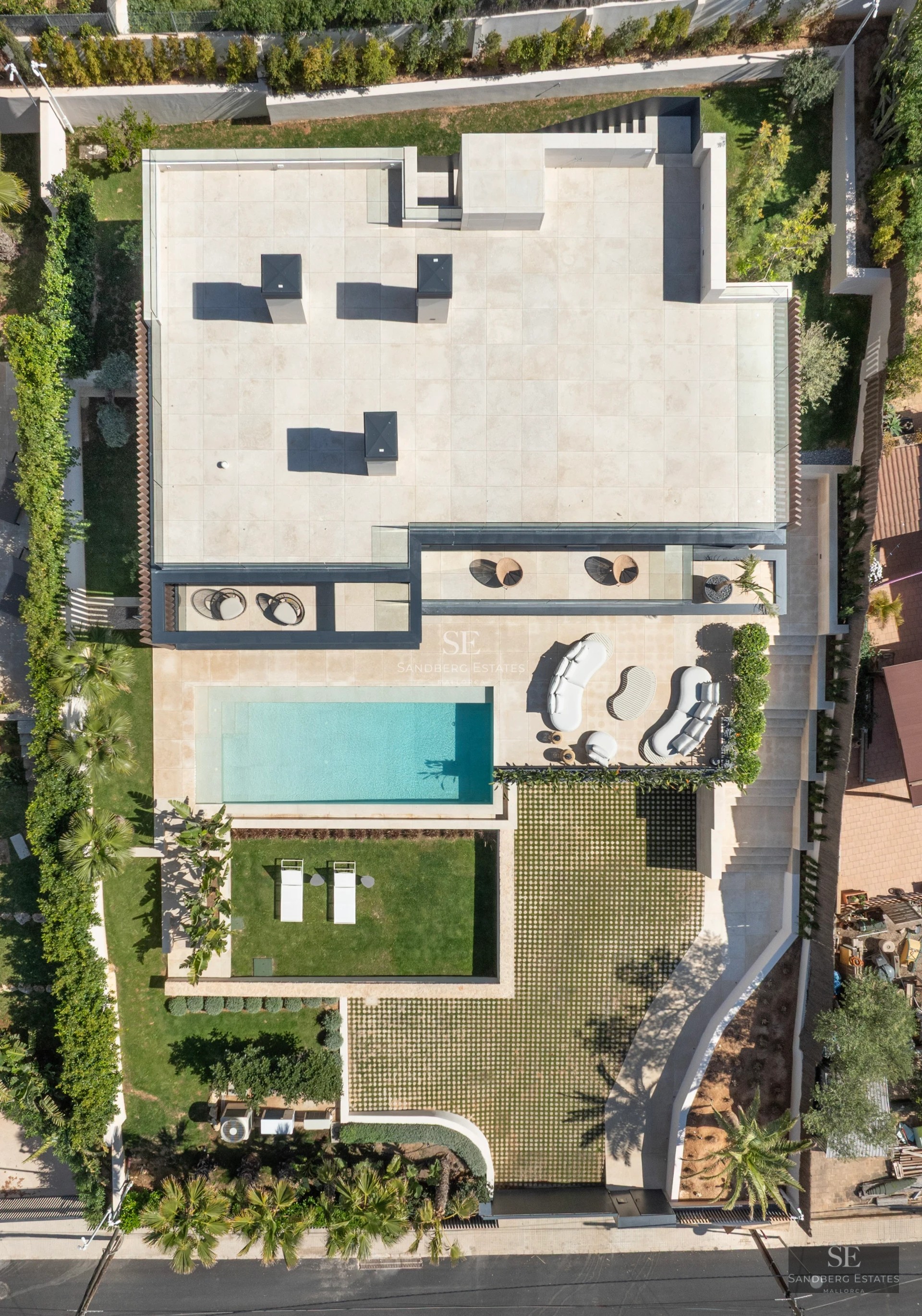 Exterior view of a modern villa with infinity pool, lush garden, and spacious terraces. Contemporary architecture.