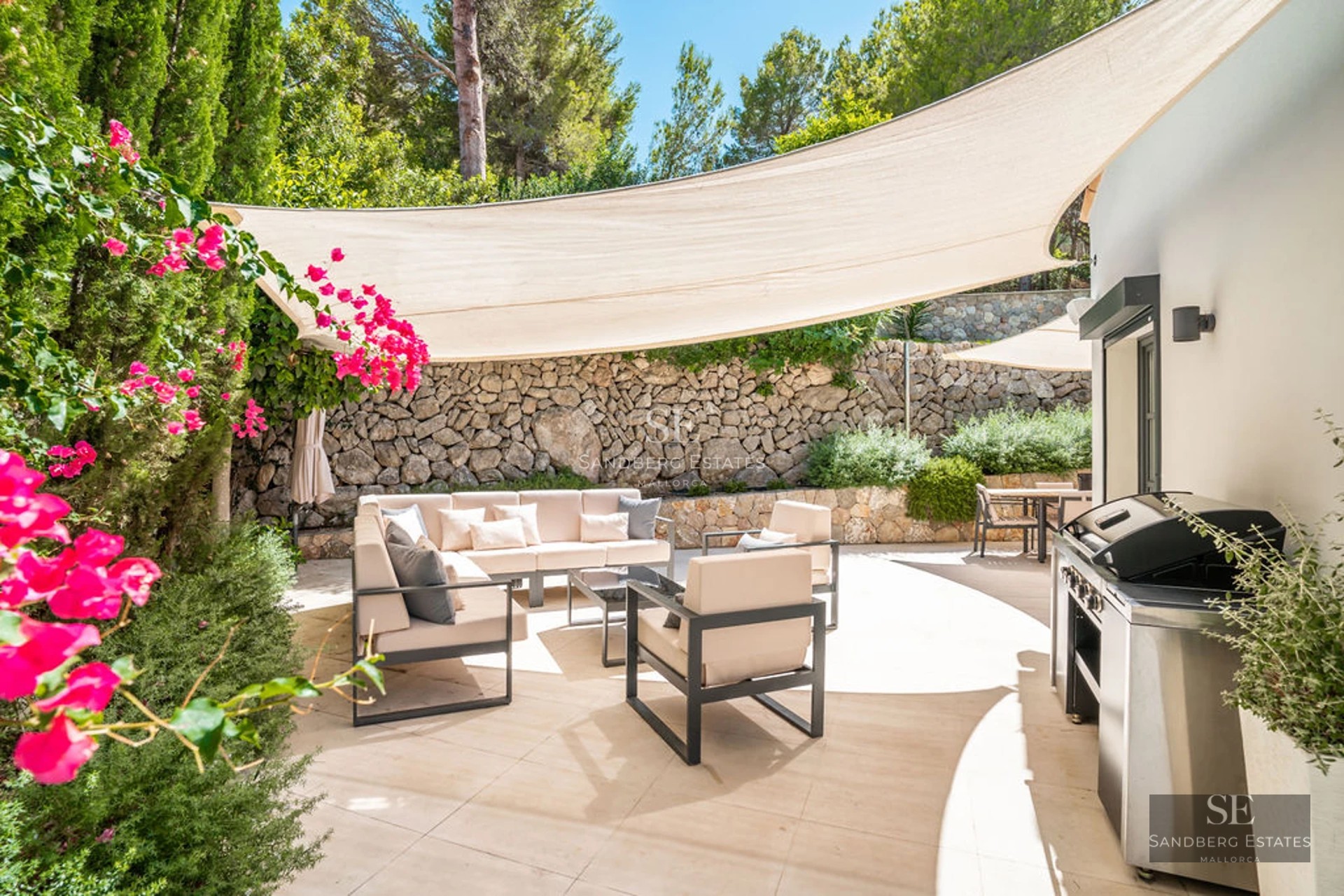 View of a modern villa featuring an infinity pool, expansive terraces, and sea views. Minimalist architecture and sleek design.